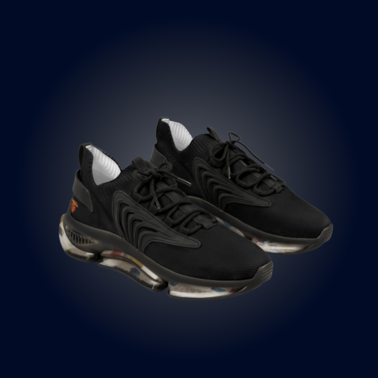 Black athletic shoes with a clear sole on a dark blue background.