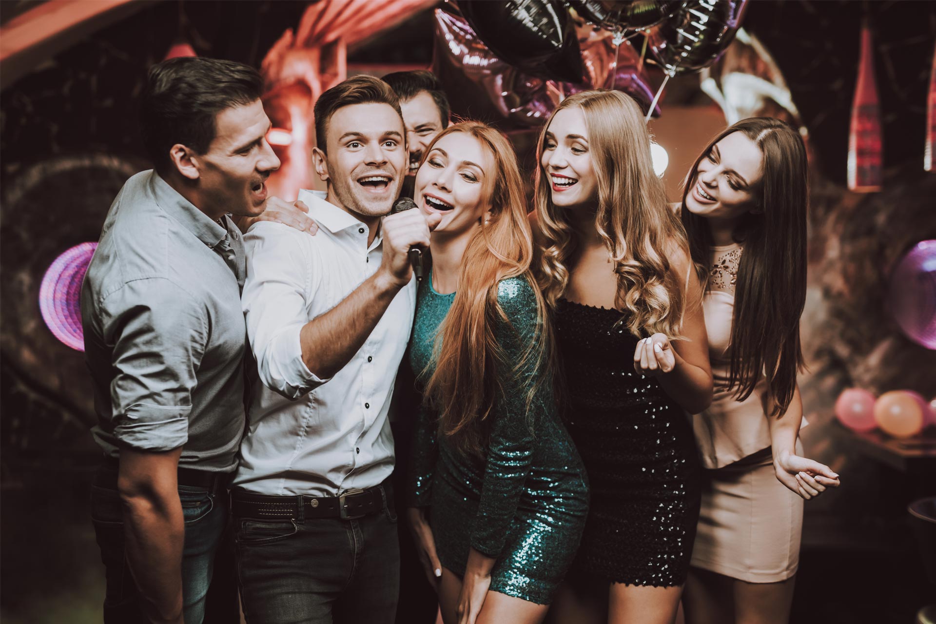 Group of Friends Playing Karaoke at Party