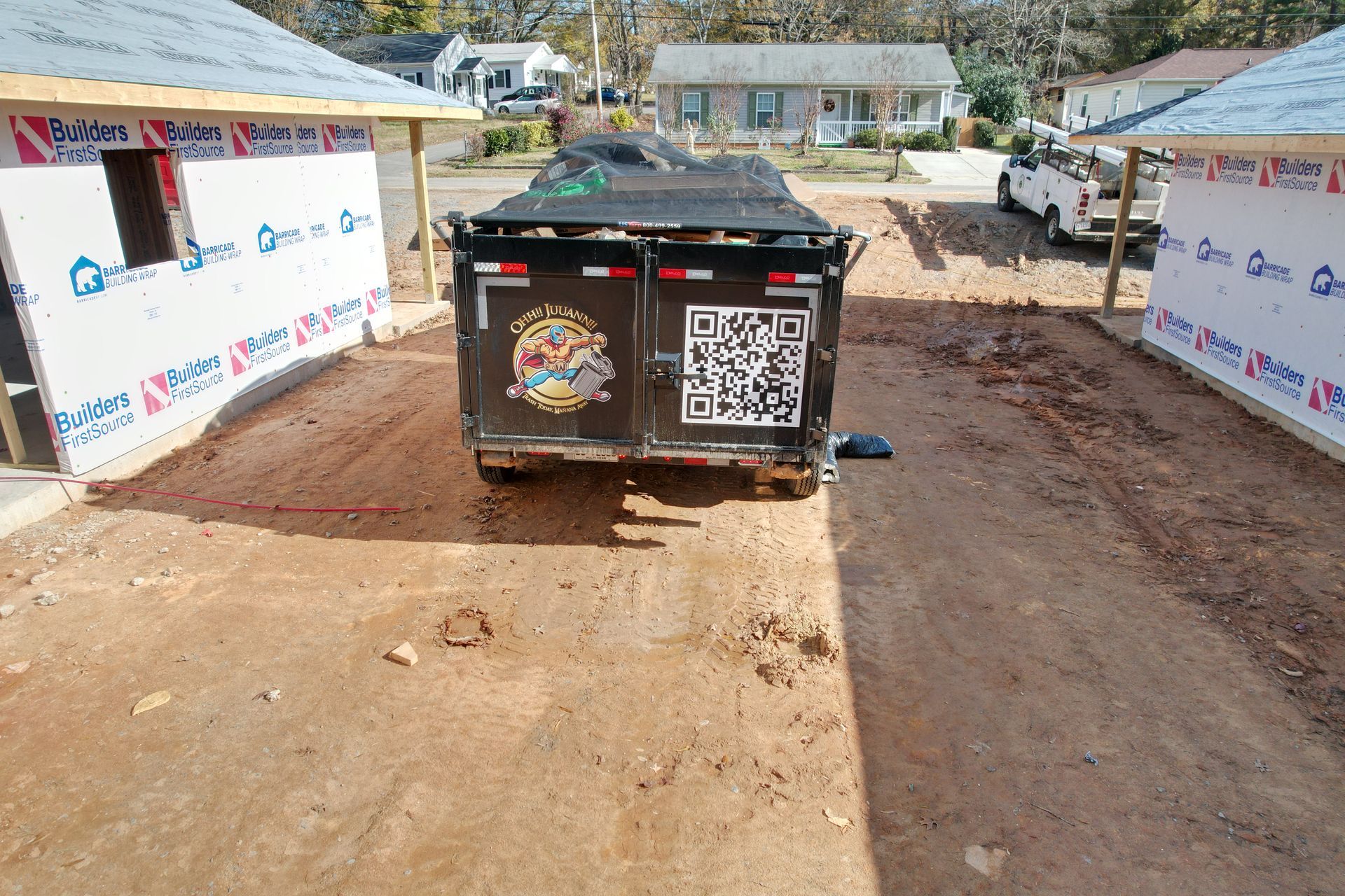A dump trailer is parked in a parking lot.