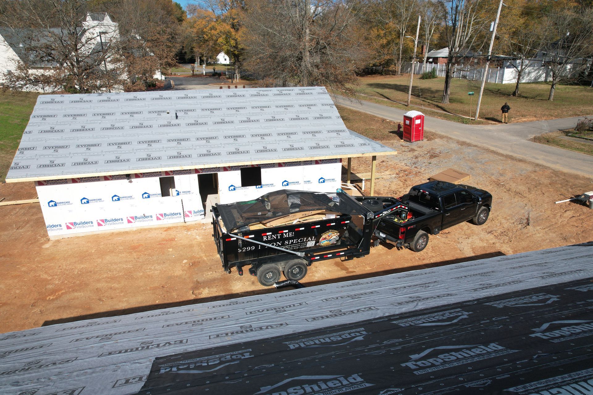 An aerial view of a truck and trailer on a roof.