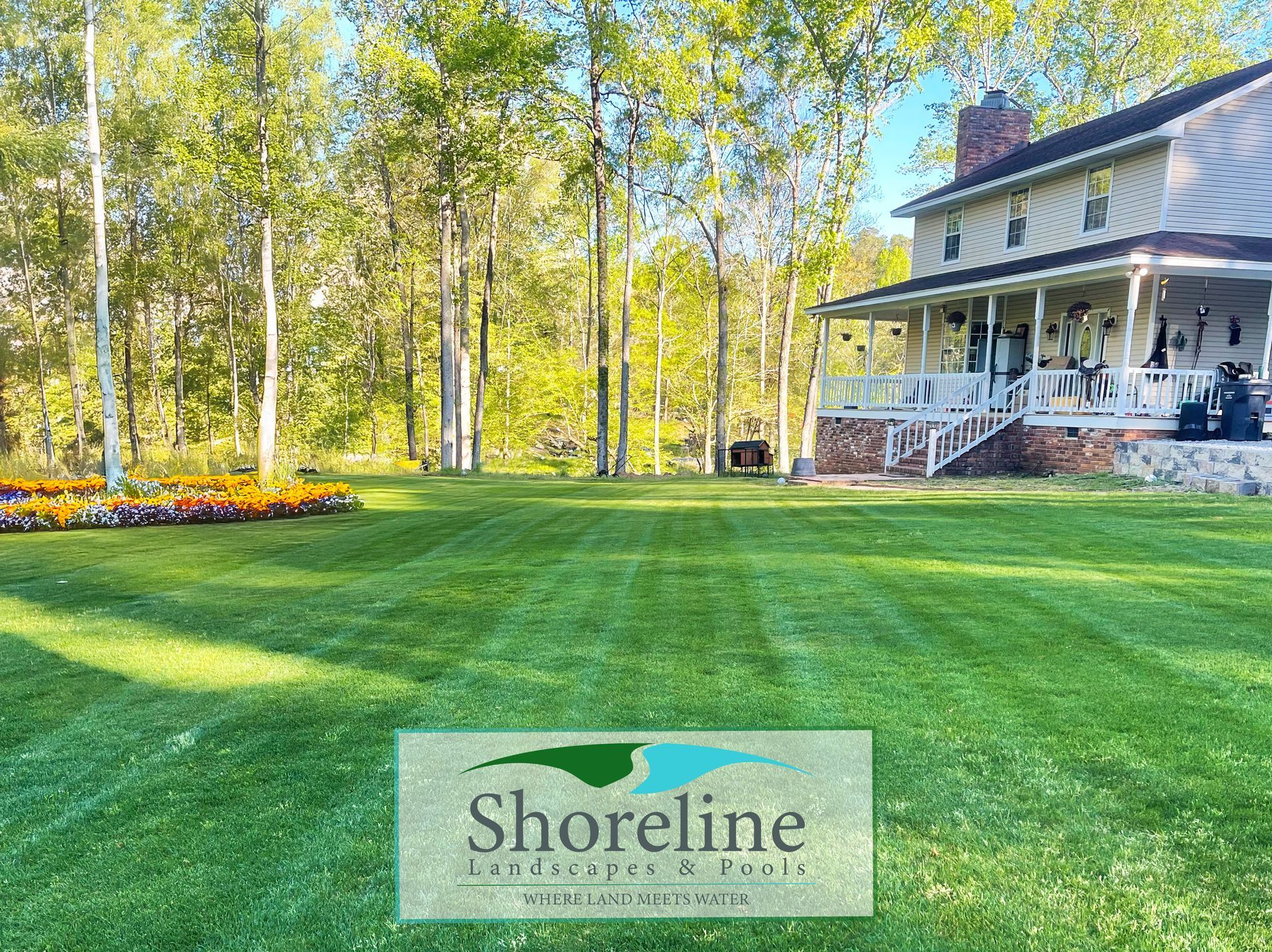 Well-manicured lawn with house and trees; 