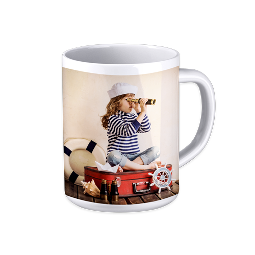 A photo mug with a little girl is sitting on a suitcase looking through a telescope.