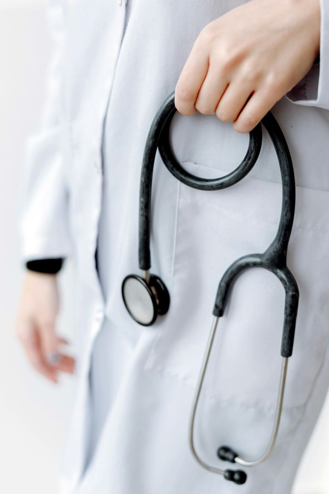A doctor is holding a stethoscope in her pocket.
