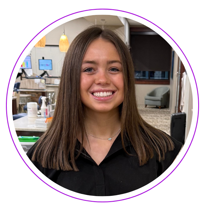 Smiling Katie D. with brown hair, wearing a black shirt, inside Small and Piers.