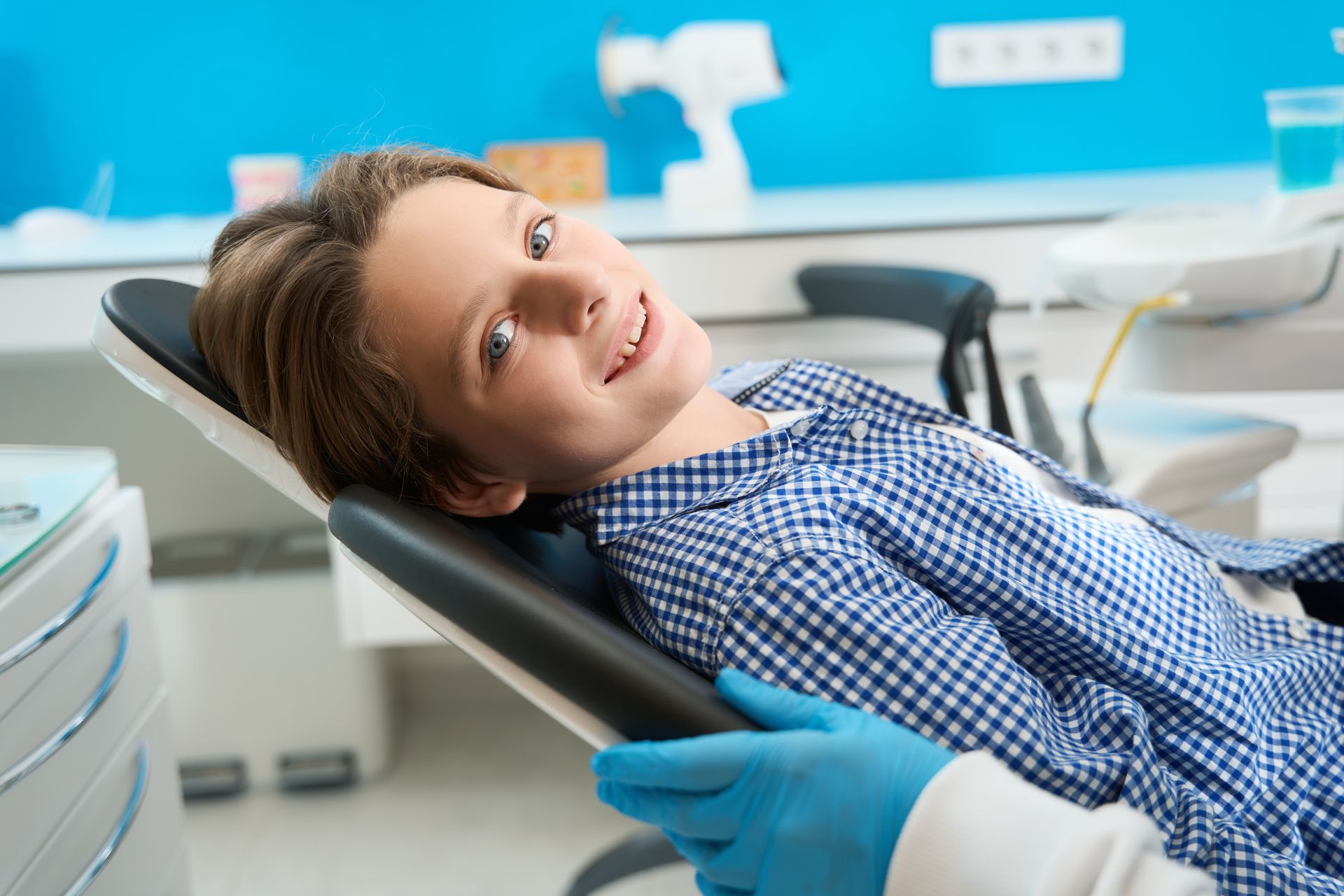 Boy in dental chair smiling at Small & Piers Orthodontis