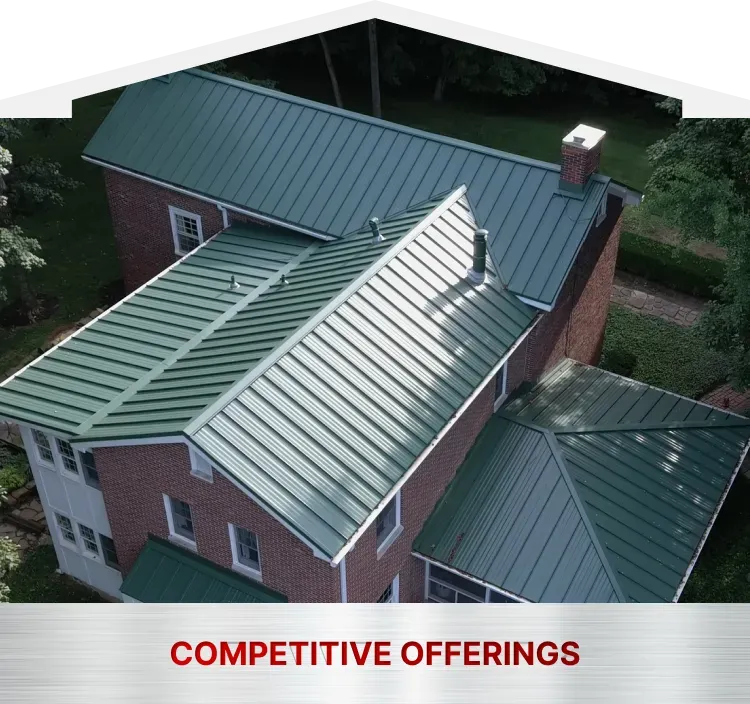 An aerial view of a house with a green metal roof