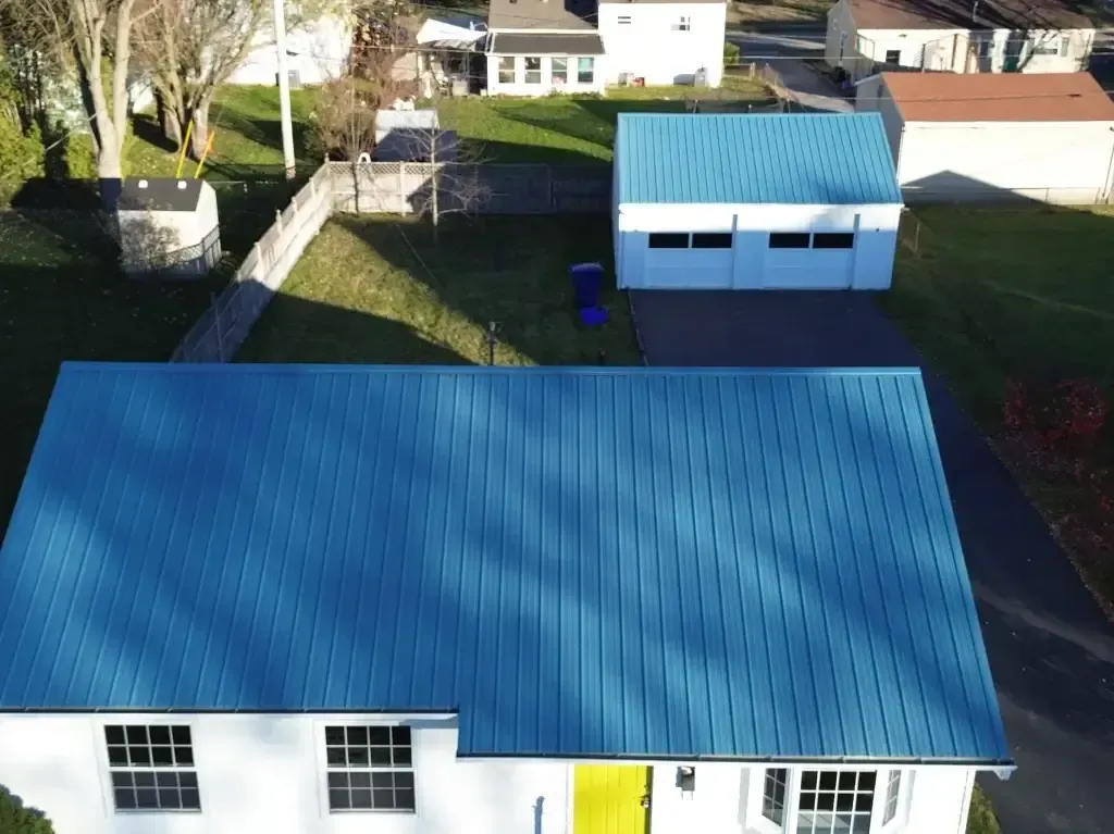 An aerial view of a house with a blue roof