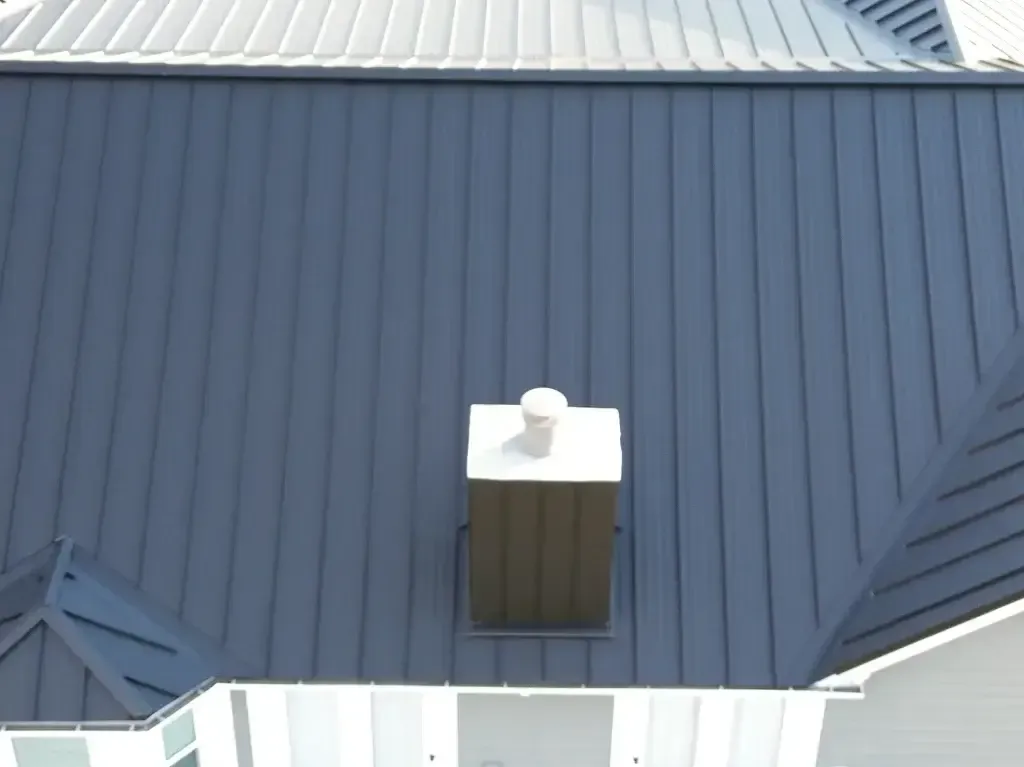 A blue roof with a white chimney on it