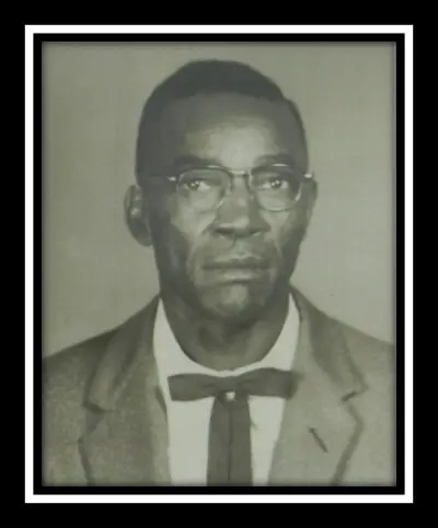 A black and white photo of a man in a suit and tie