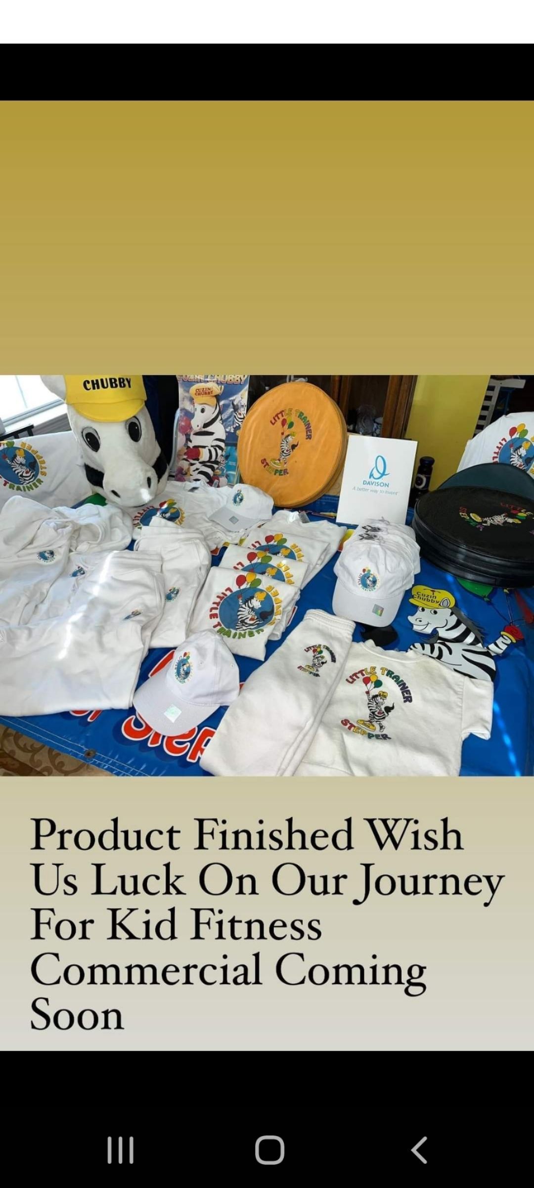 A phone screen shows a bunch of clothes on a table.