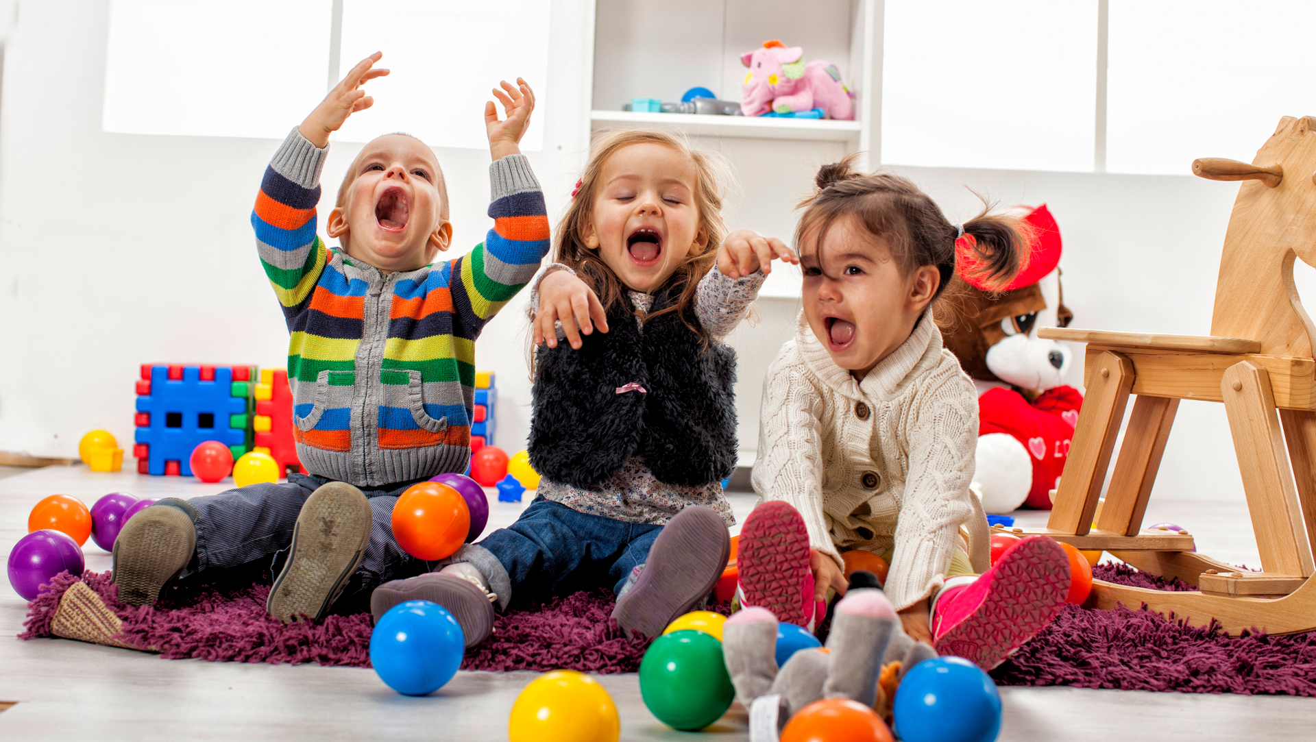 A group of children are dancing together in a classroom.