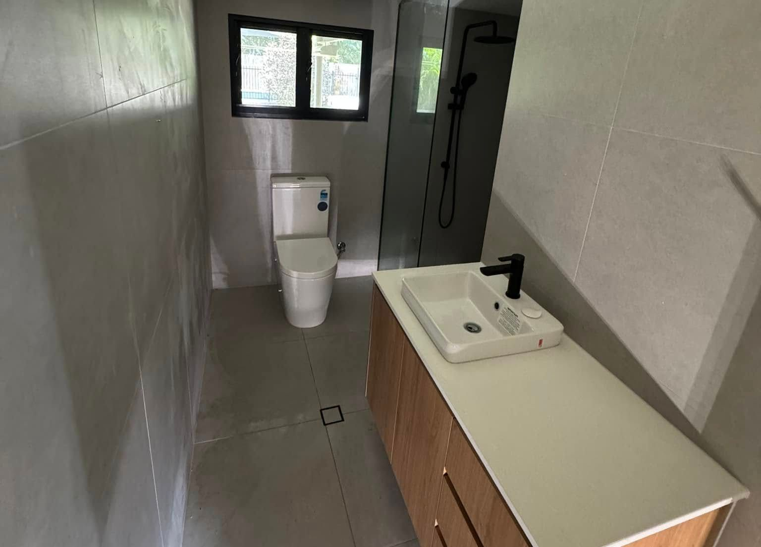 Gray Tiled Floor, Drain, and Bucket — Northern Plumbing Maintenance & Repairs in Leanyer, NT