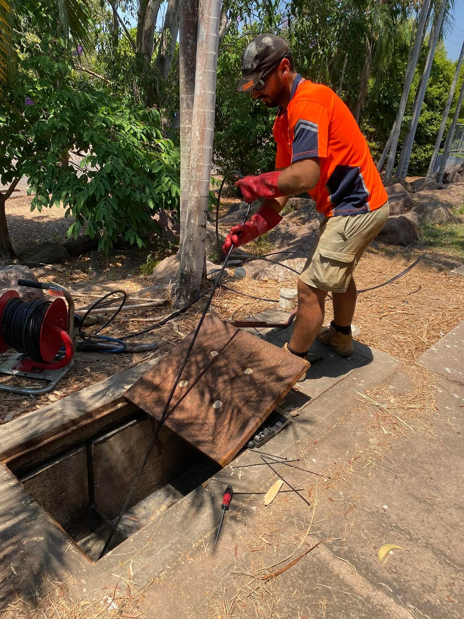Mini Excavator Digging a Trench Near a House — Northern Plumbing Maintenance & Repairs in Leanyer, NT