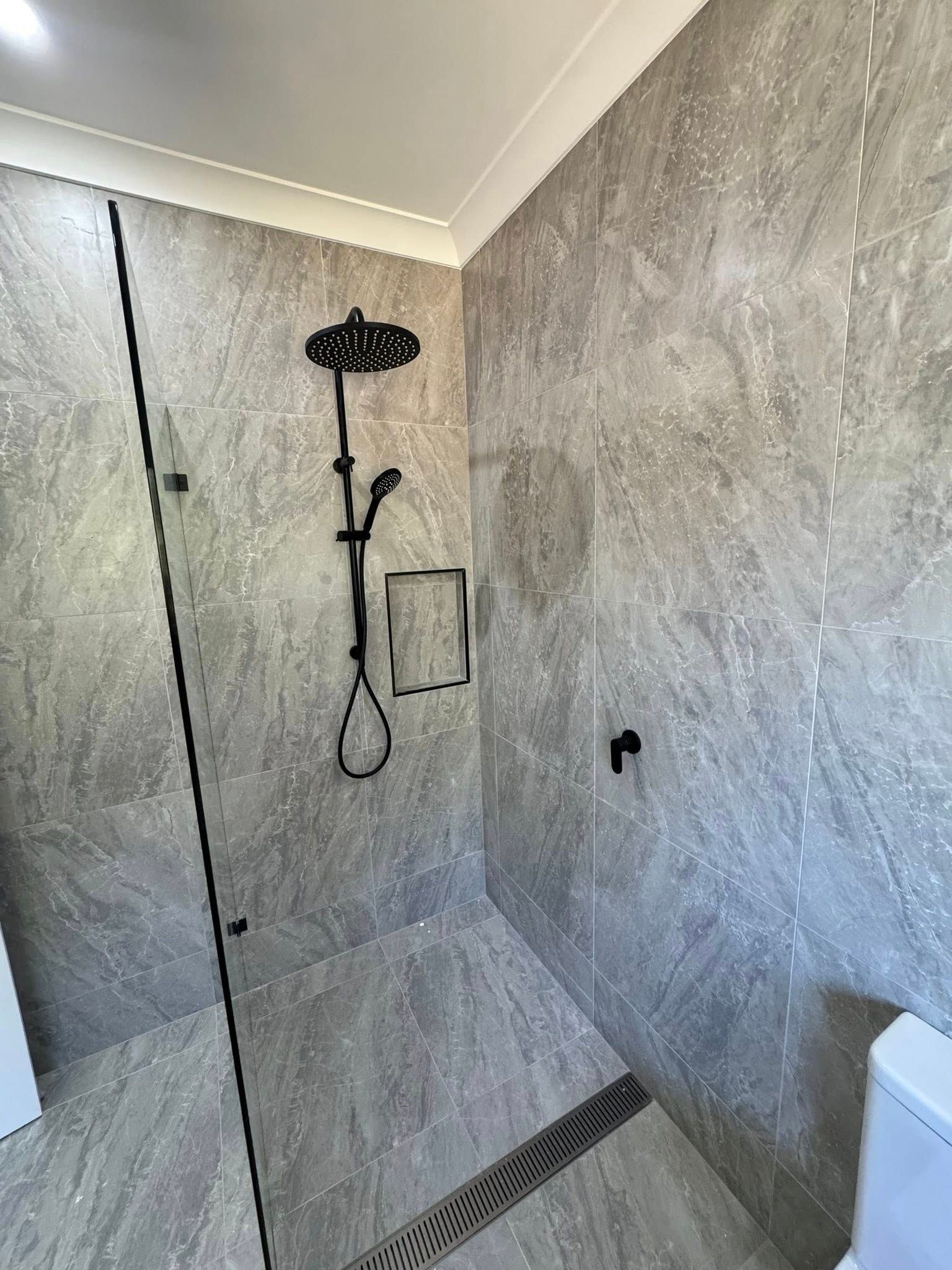 Small Bathroom With a Toilet, Sink, and Window — Northern Plumbing Maintenance & Repairs in Leanyer, NT