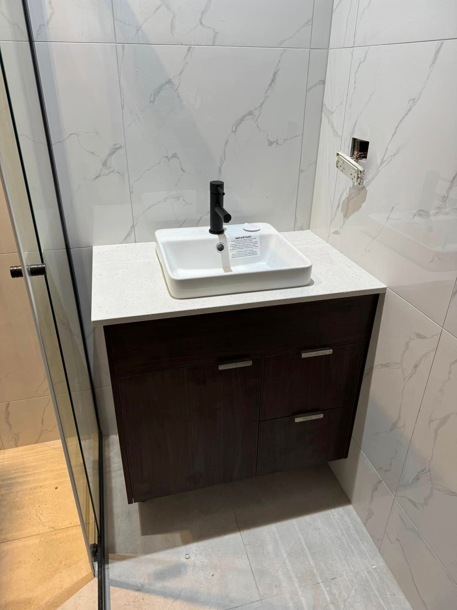 Wet Floor With a Yellow X and a Broom — Northern Plumbing Maintenance & Repairs in Leanyer, NT