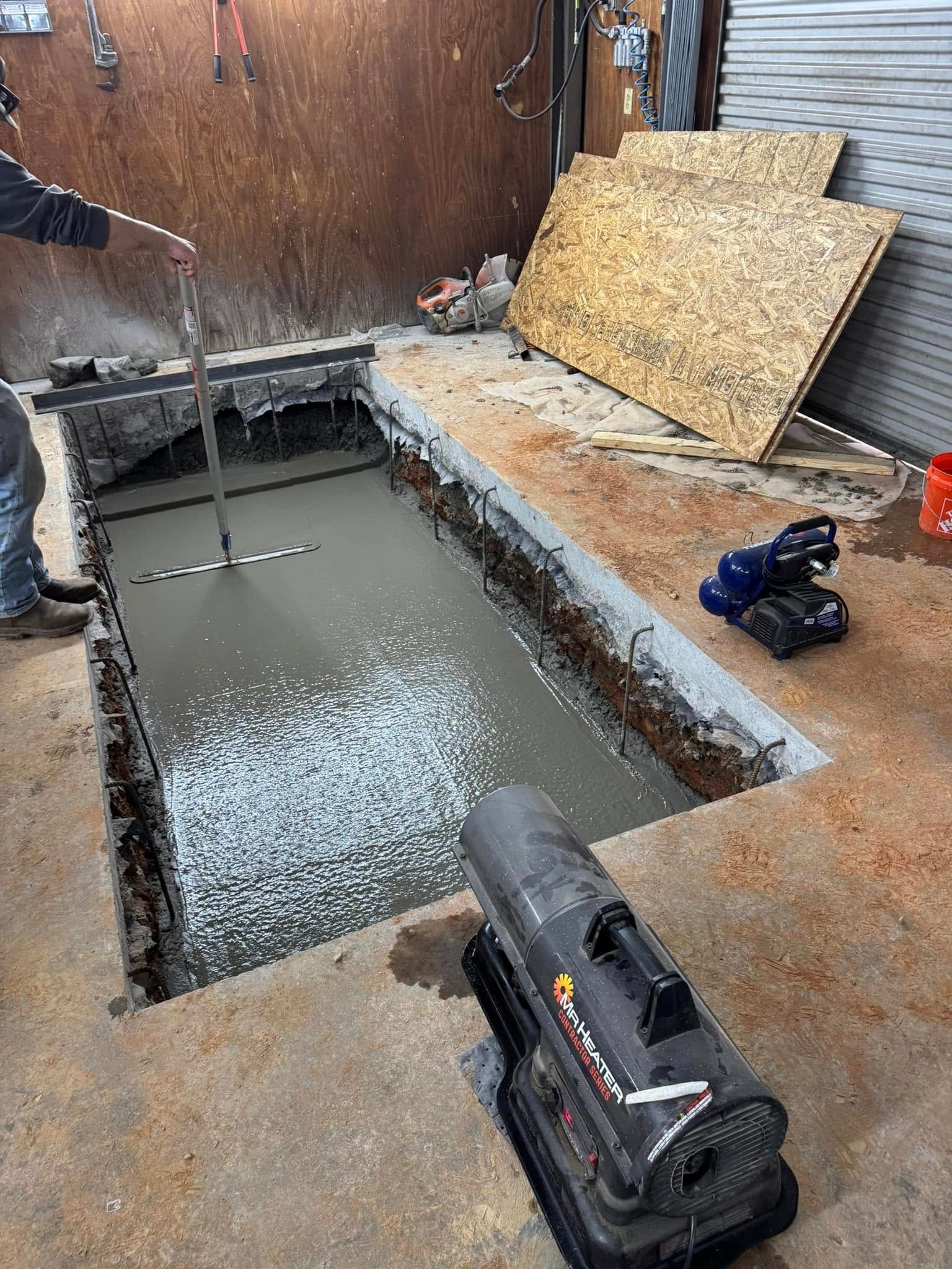 Woman in straw hat smiles, holding wine glass near a lake.