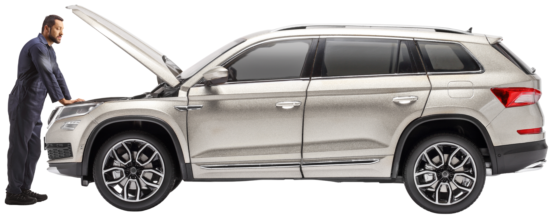 A mechanic in blue coveralls examines a silver SUV with its hood open.