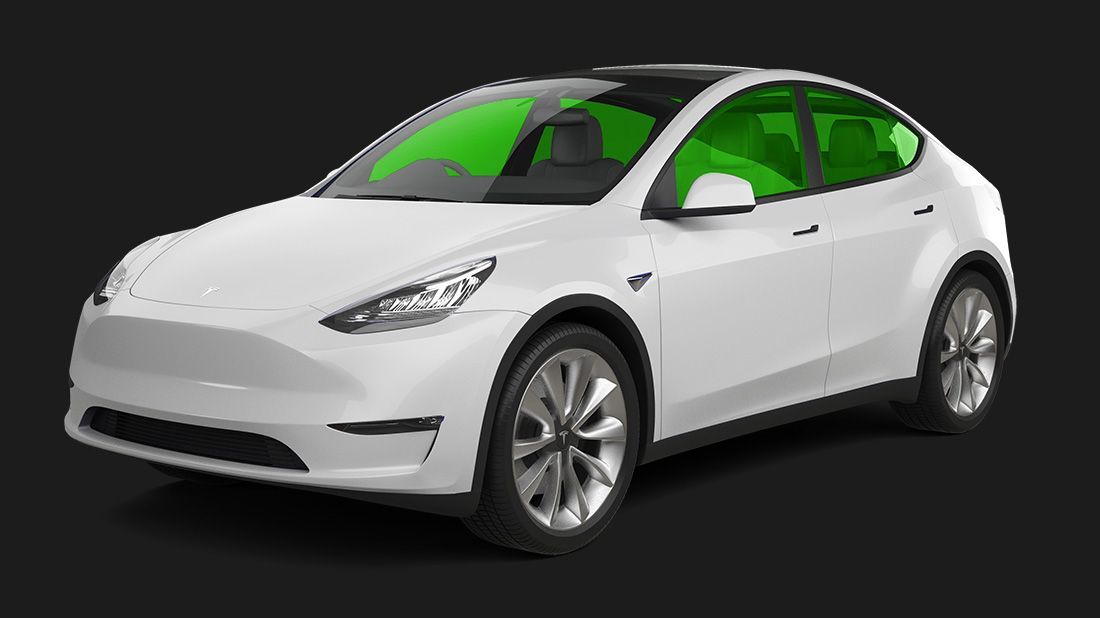 A white tesla model y with green windows on a black background.