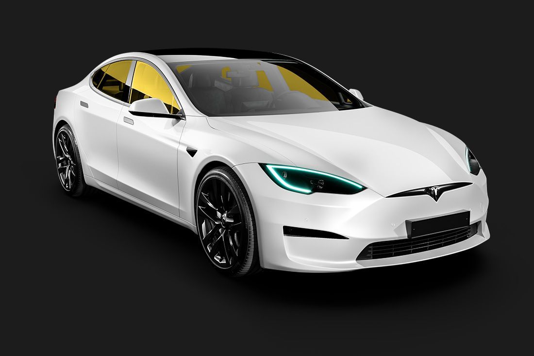 A white tesla model s is sitting on a black background.