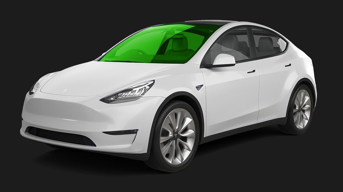A white tesla model y with a green windshield on a black background.
