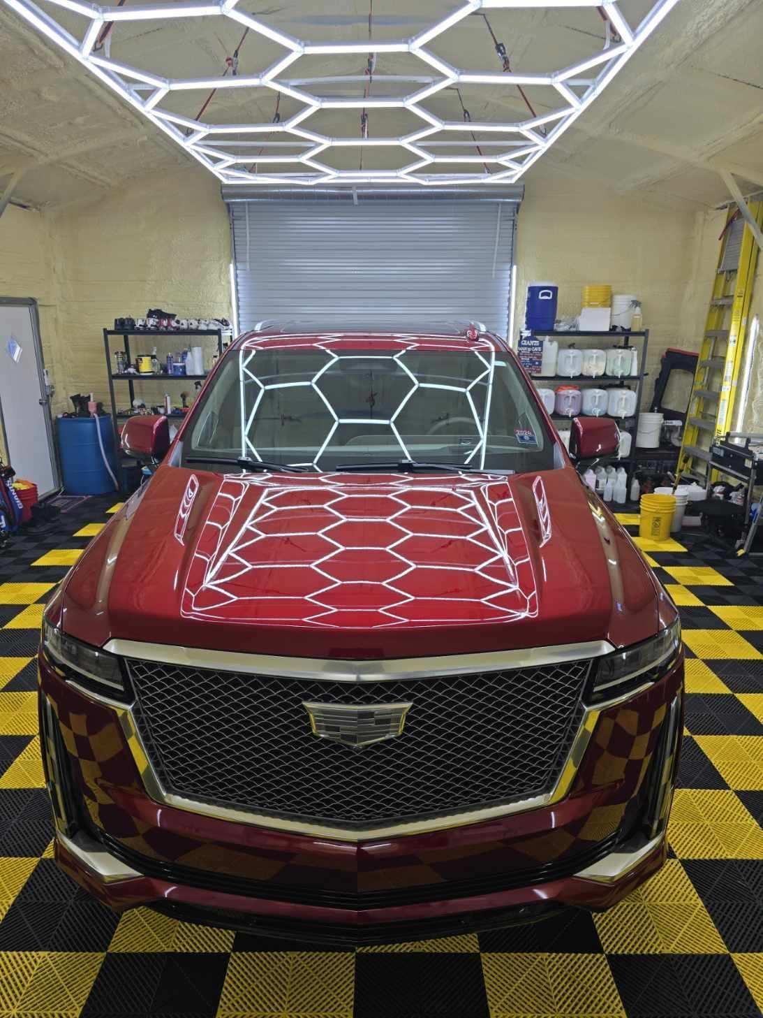 A red car with a sticker on the windshield that says 50724