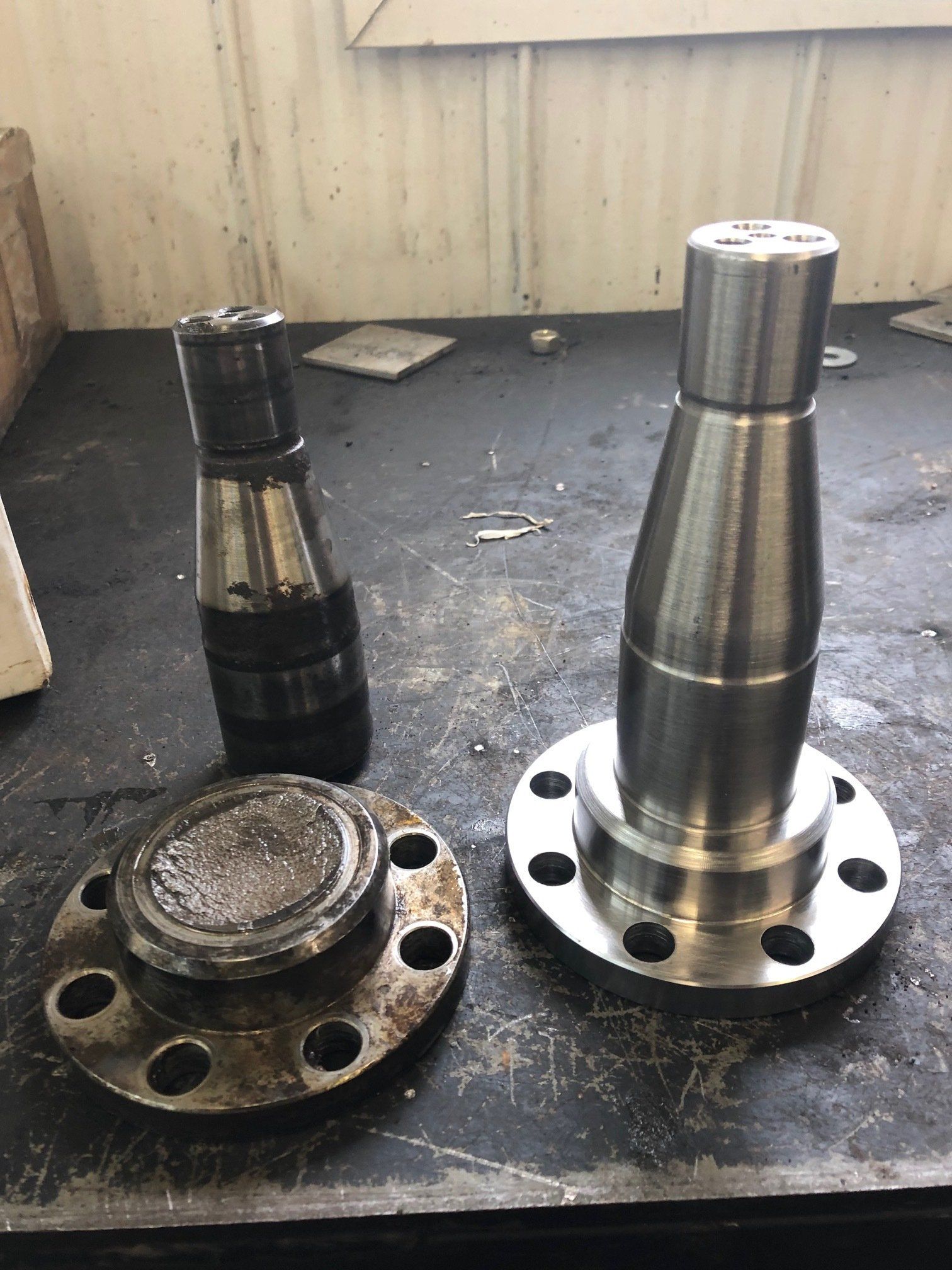 A bunch of metal parts are sitting on a table.