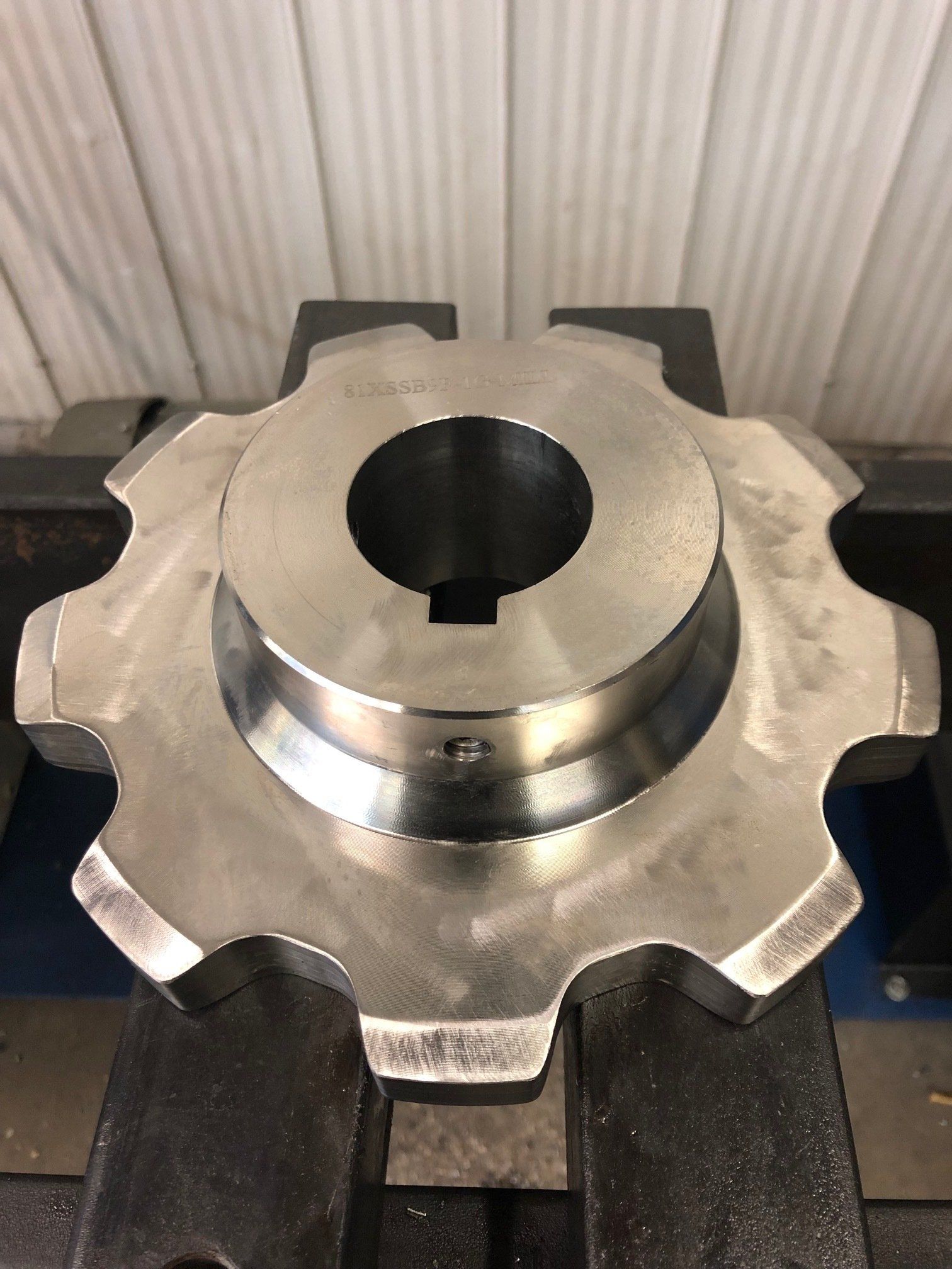 A close up of a metal gear with a hole in the middle.