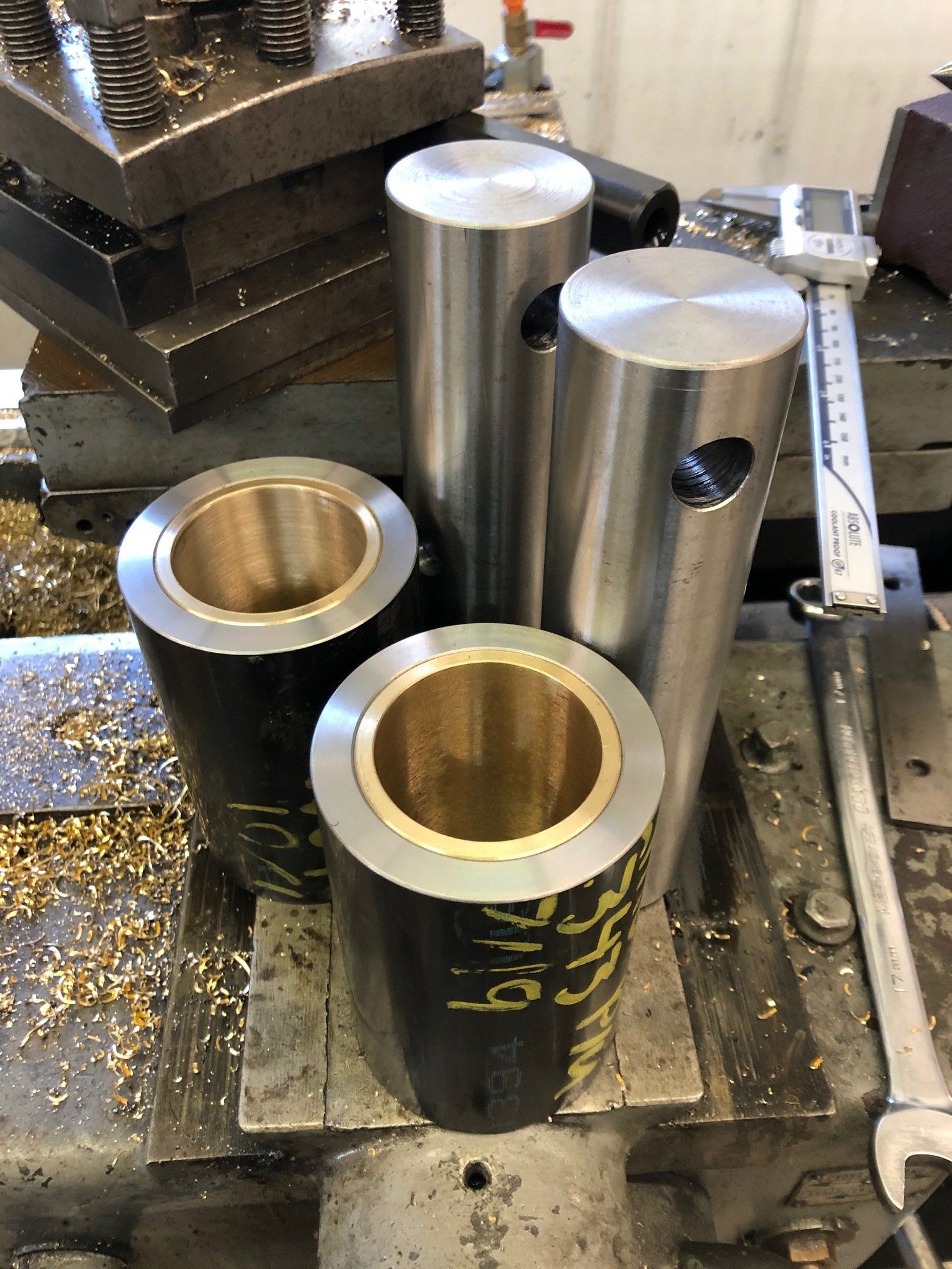 A bunch of metal cylinders are sitting on top of a machine.