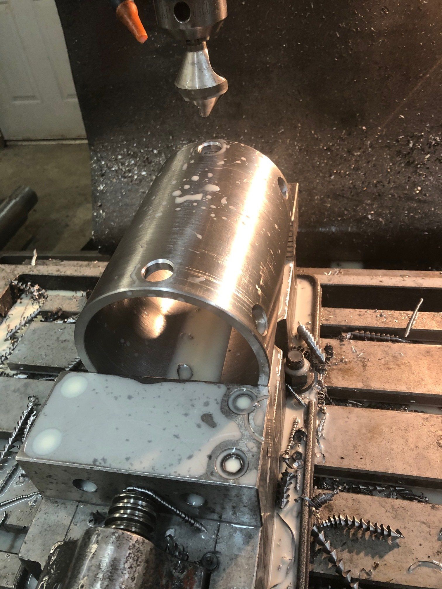 A machine is cutting a piece of metal on a table.