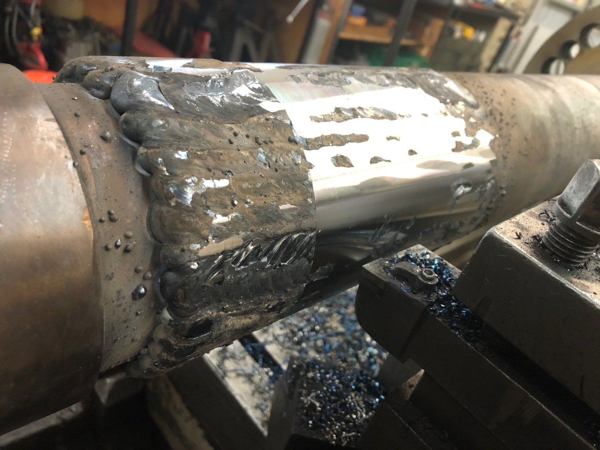 A piece of metal is being worked on by a machine.