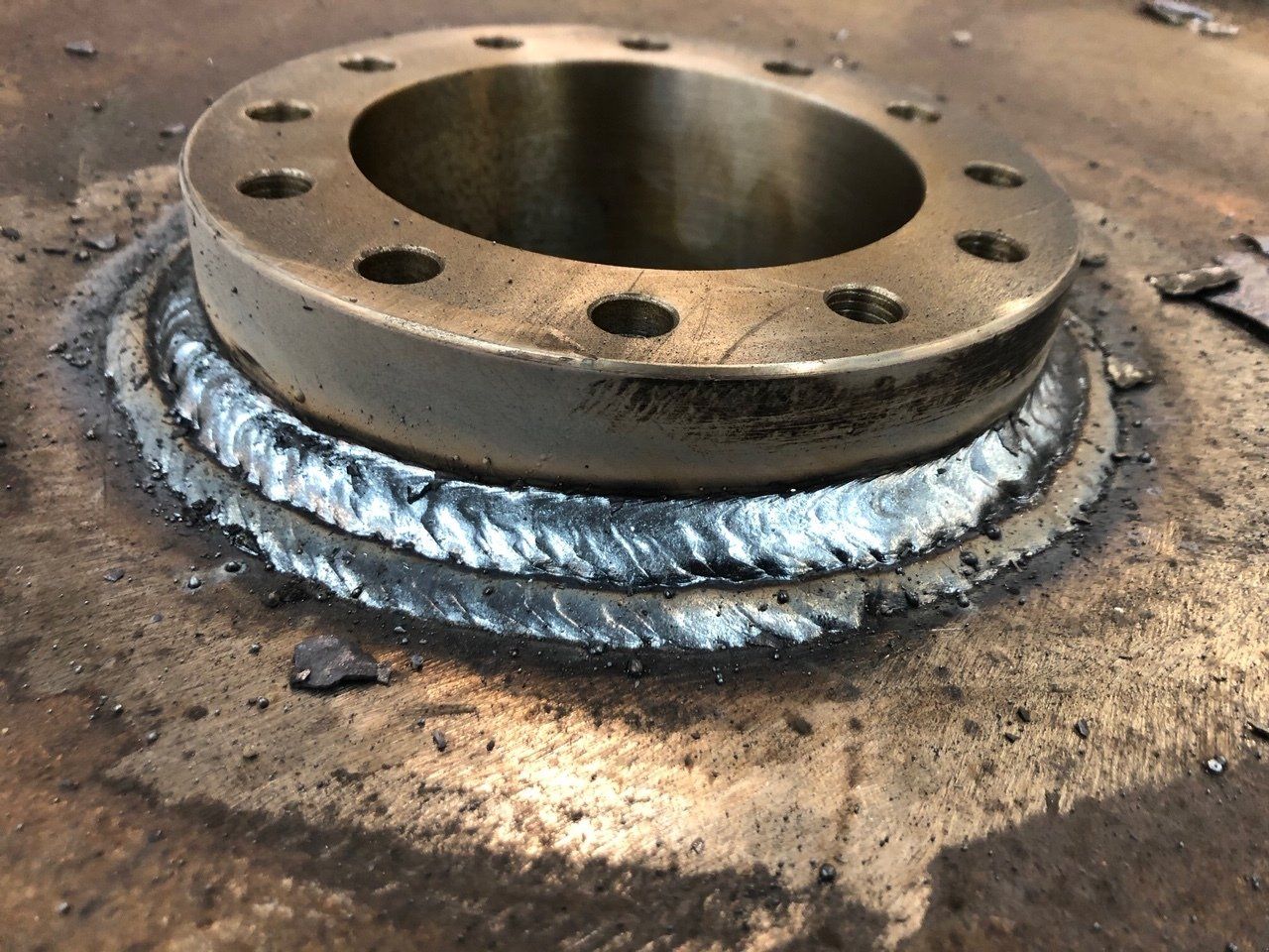 A close up of a metal piece with holes in it