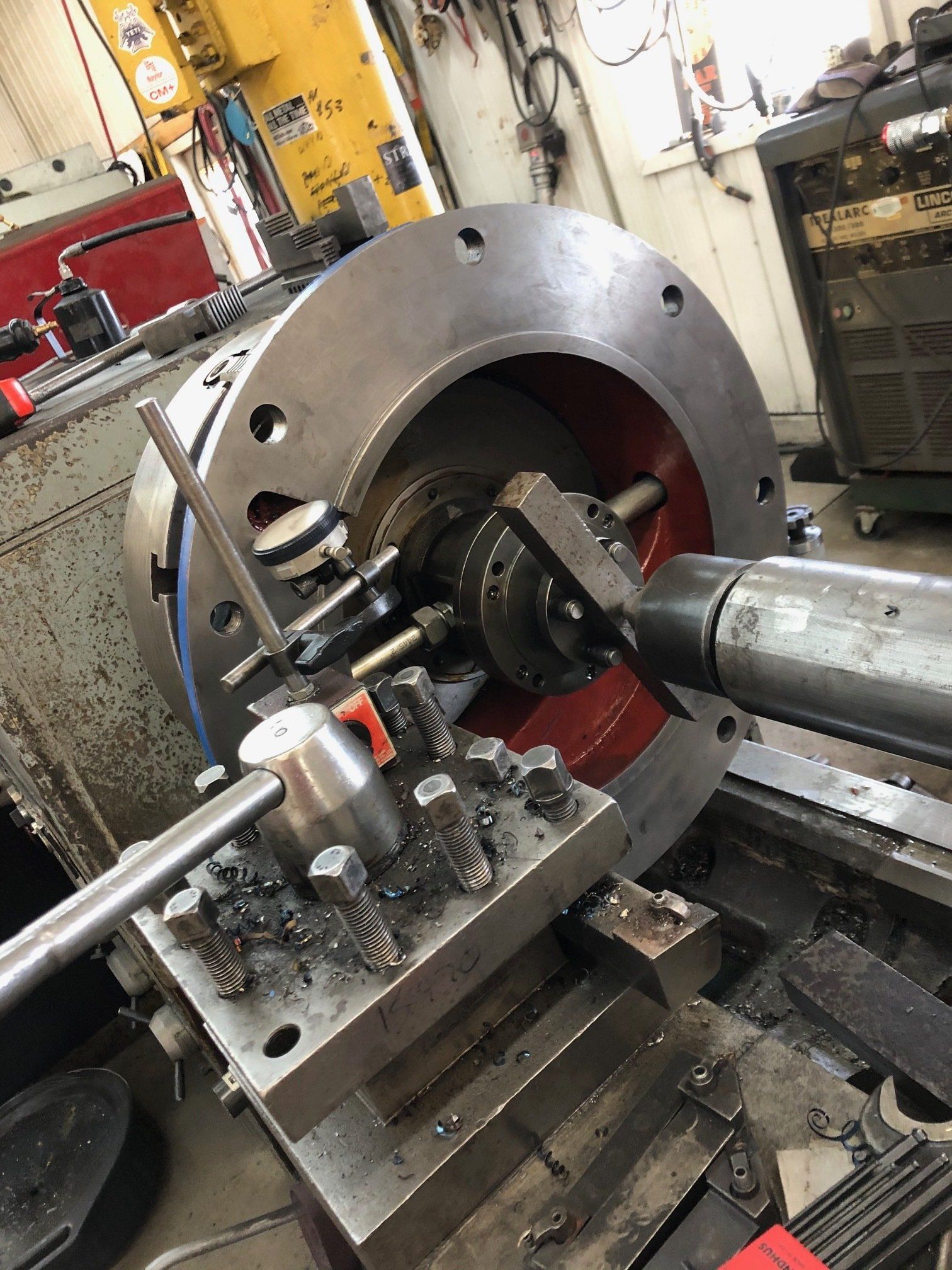 A machine is cutting a piece of metal on a lathe.