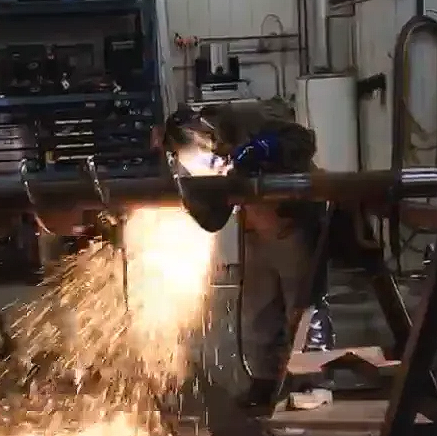 a man welding with lots of sparks flying