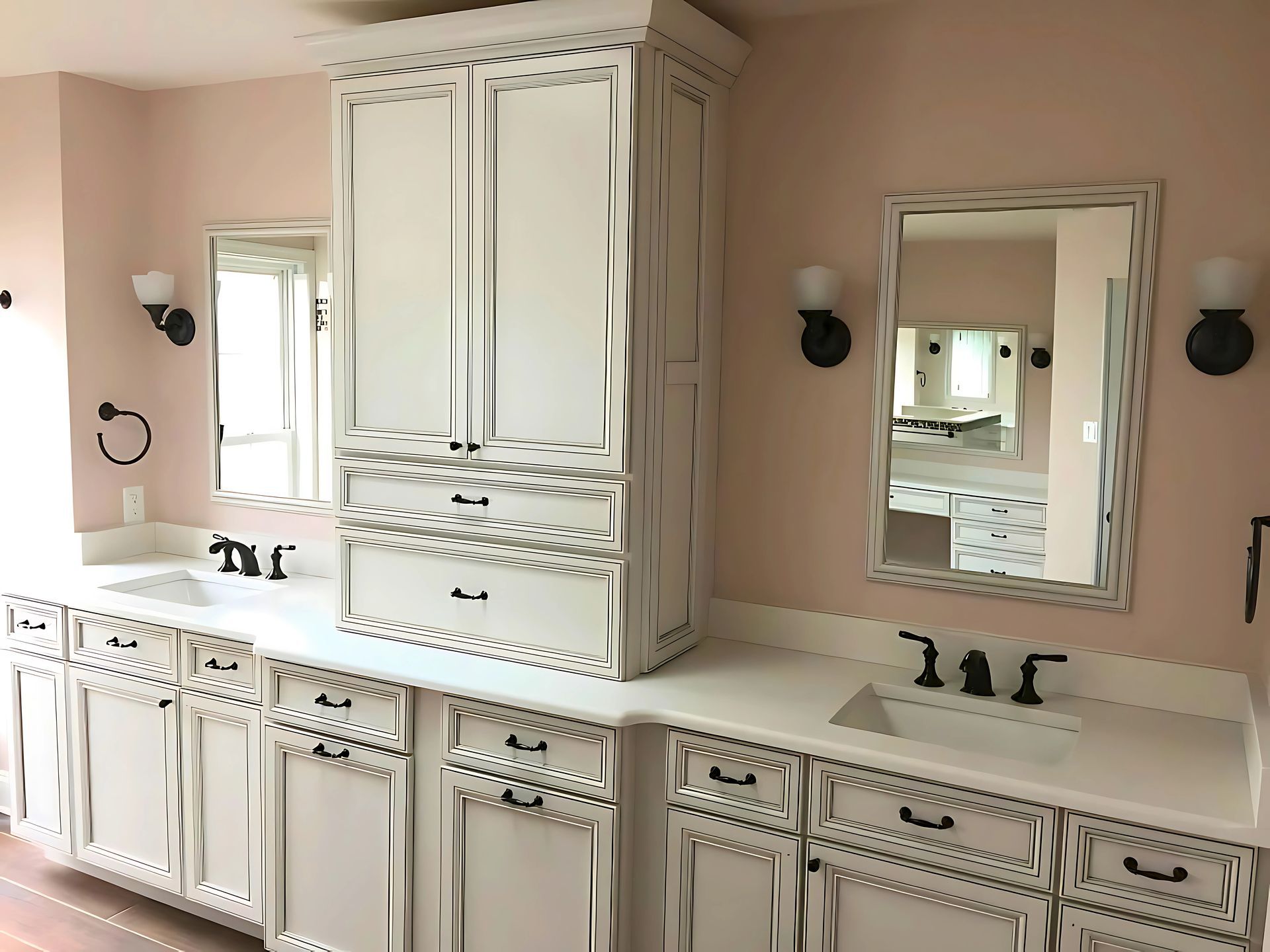 A bathroom with white cabinets , sinks and mirrors