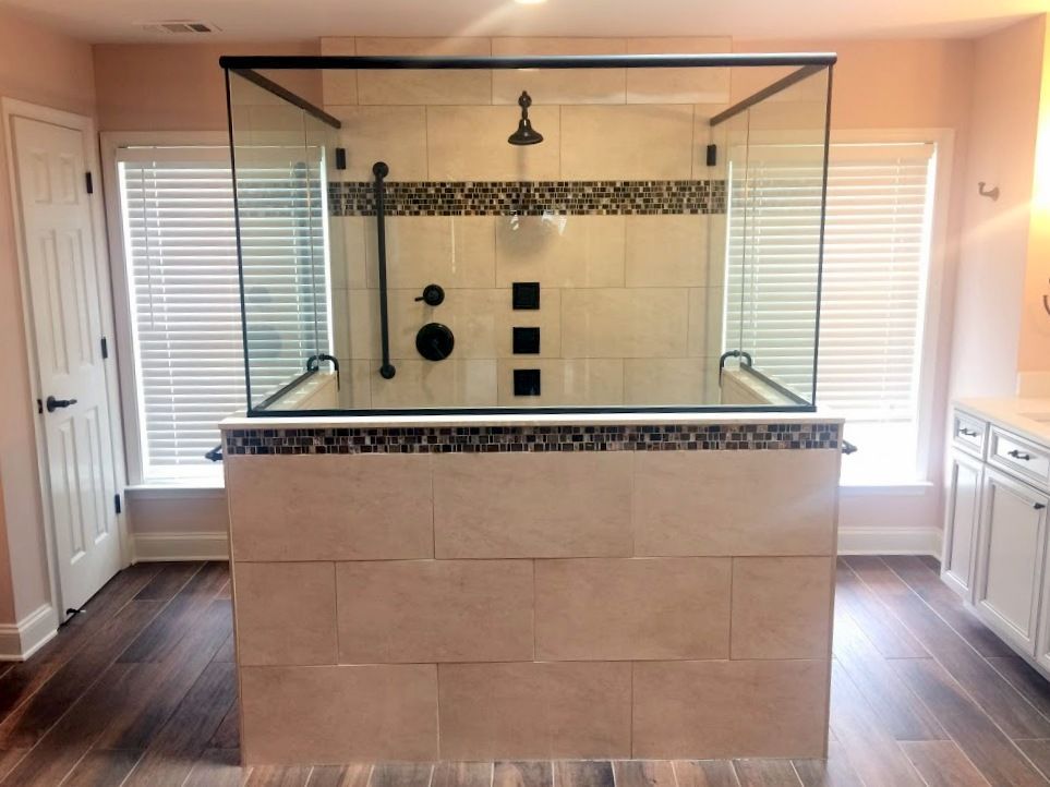 A bathroom with a walk in shower and a window