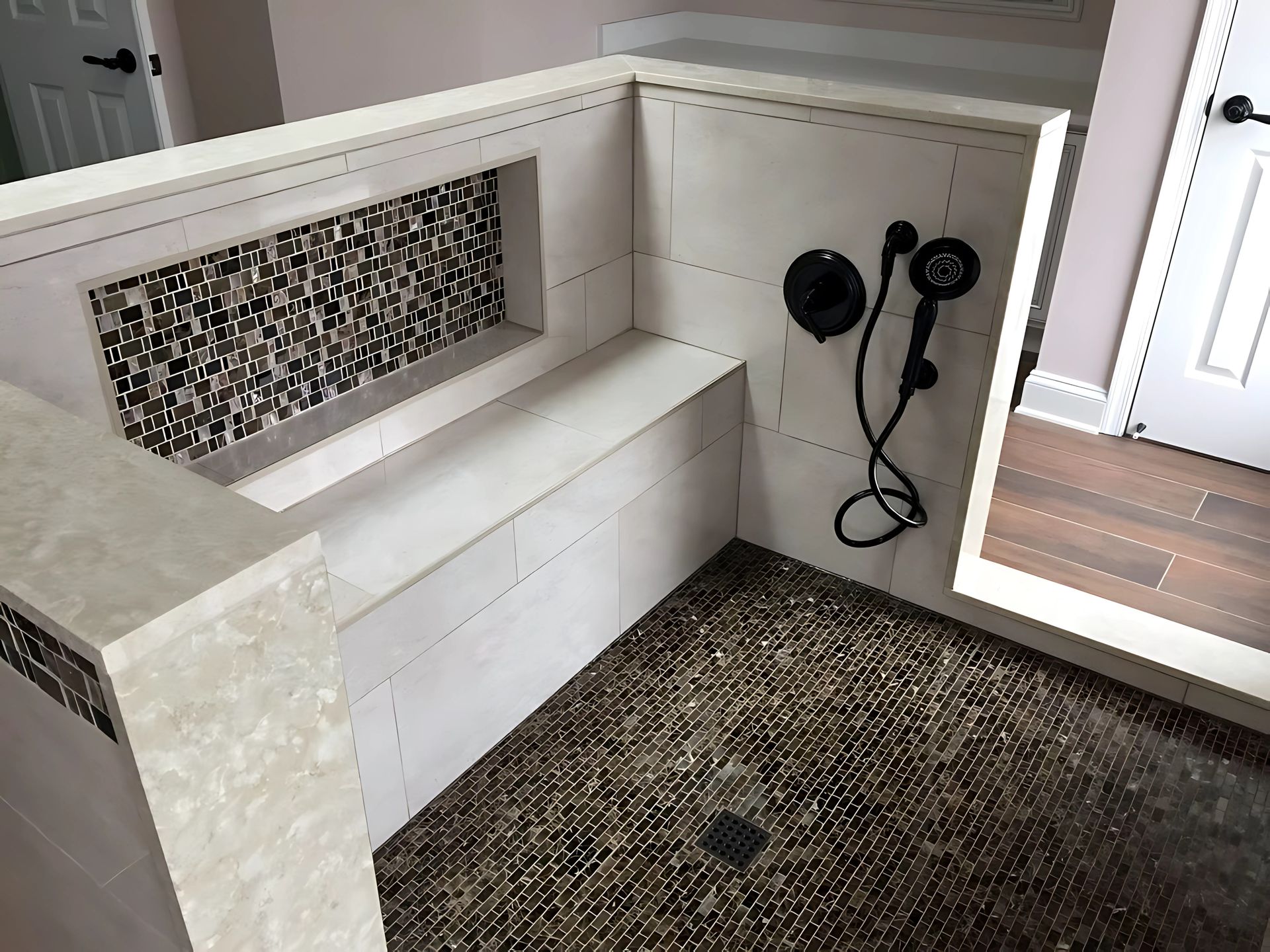 A bathroom with a bench and a shower.