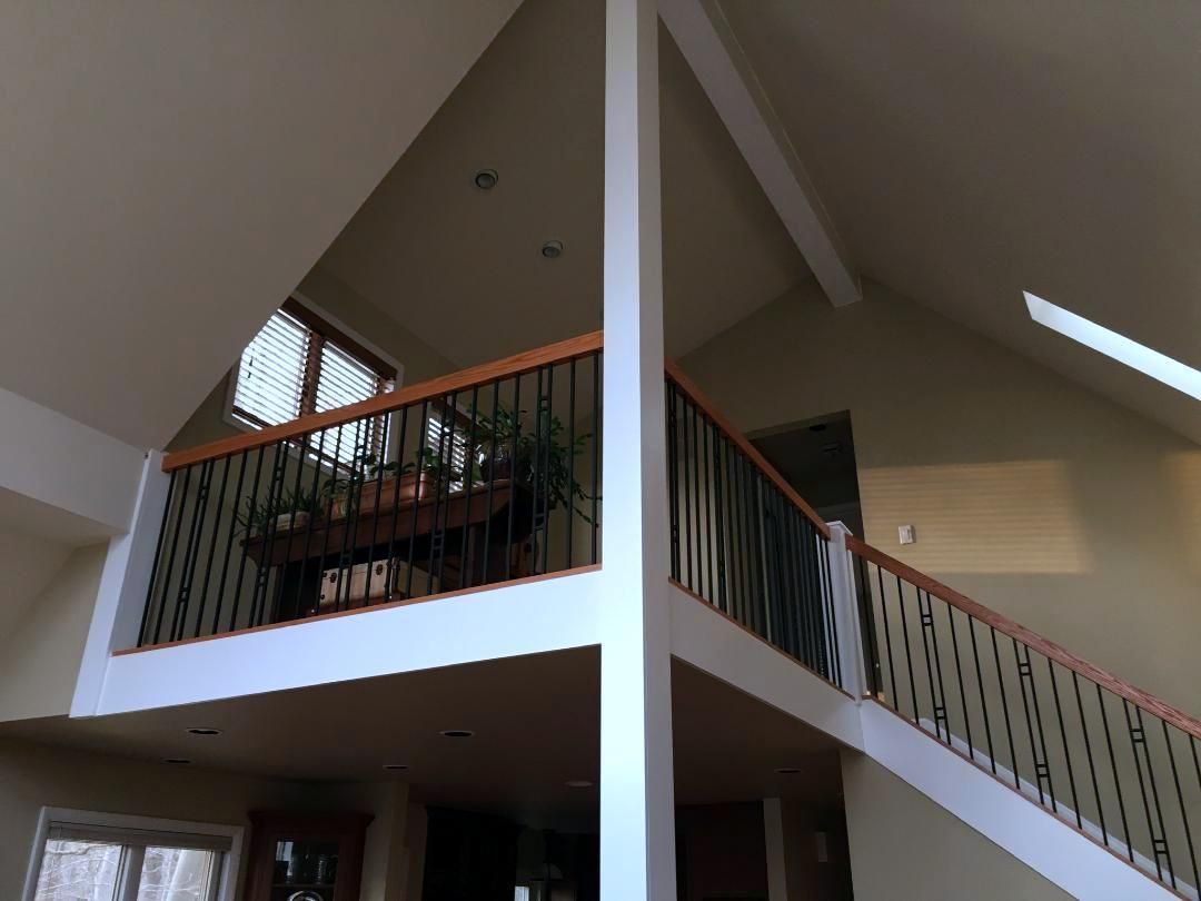 A house with a balcony and stairs leading up to it