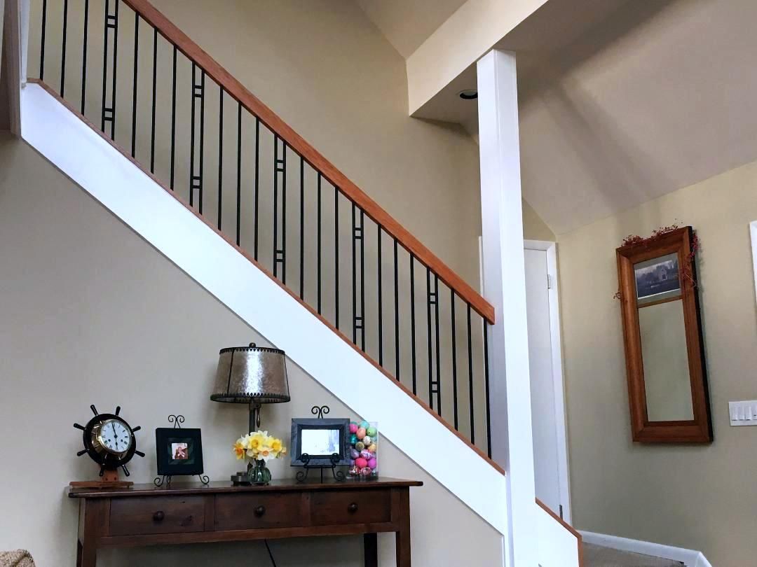 A staircase in a house with a table underneath it