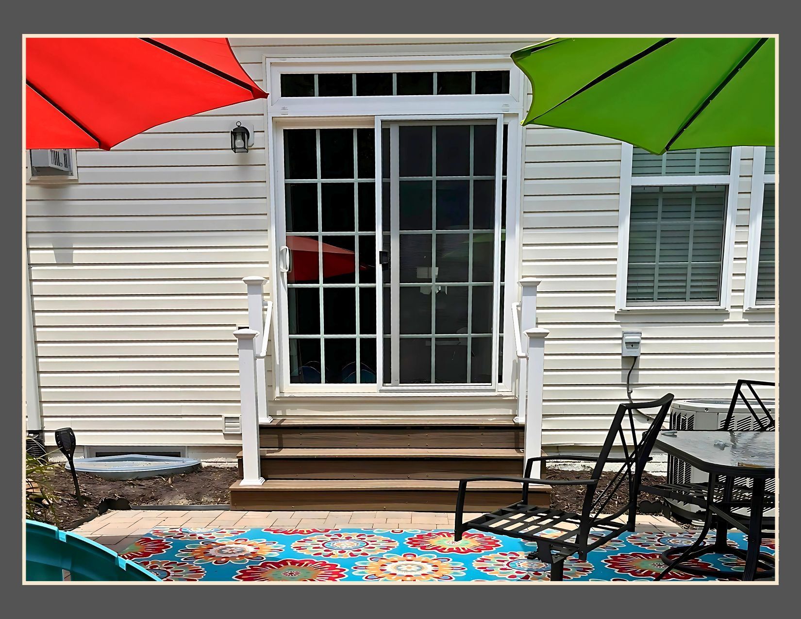 A white house with a sliding glass door and two umbrellas