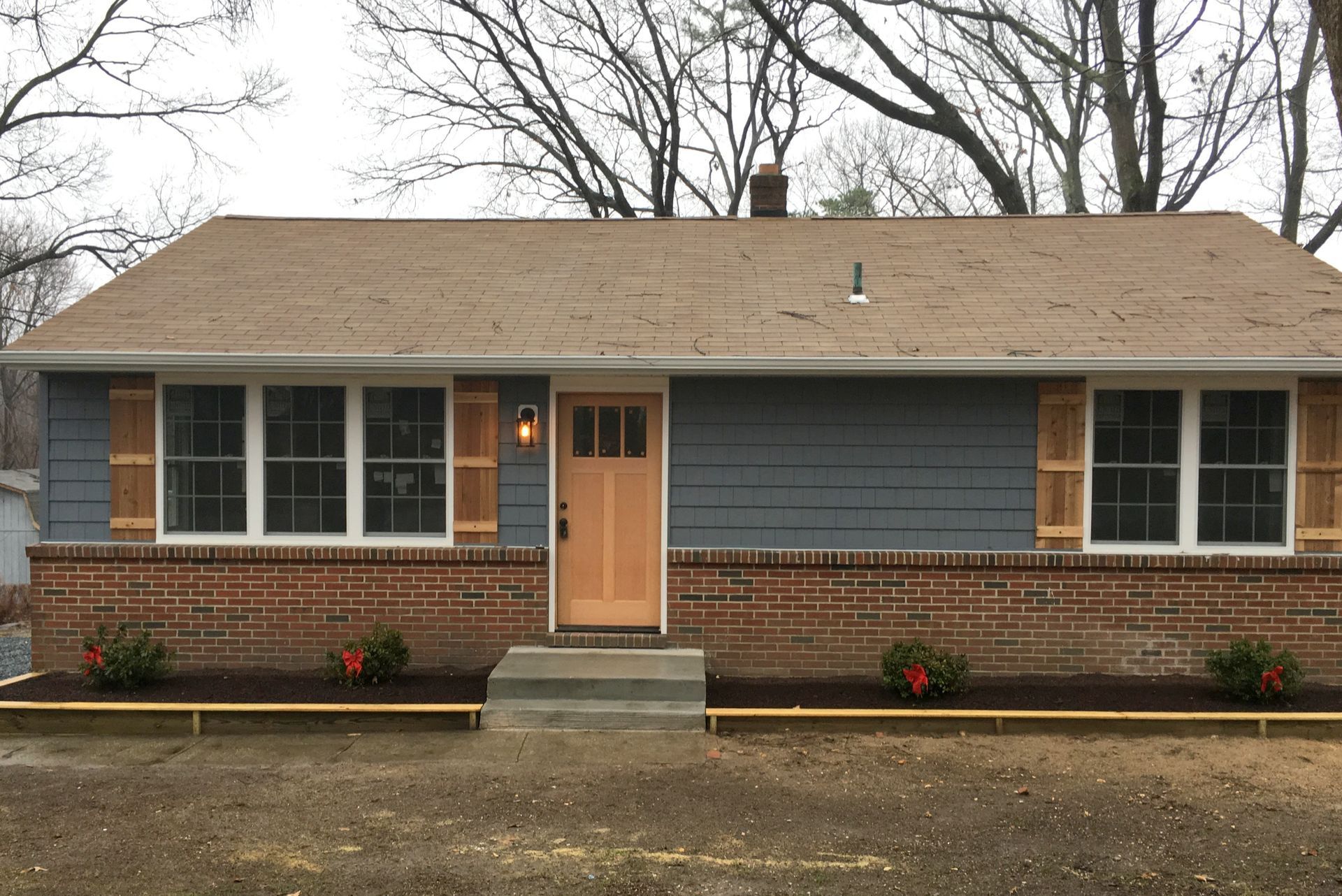 A house with a blue siding and a brown roof