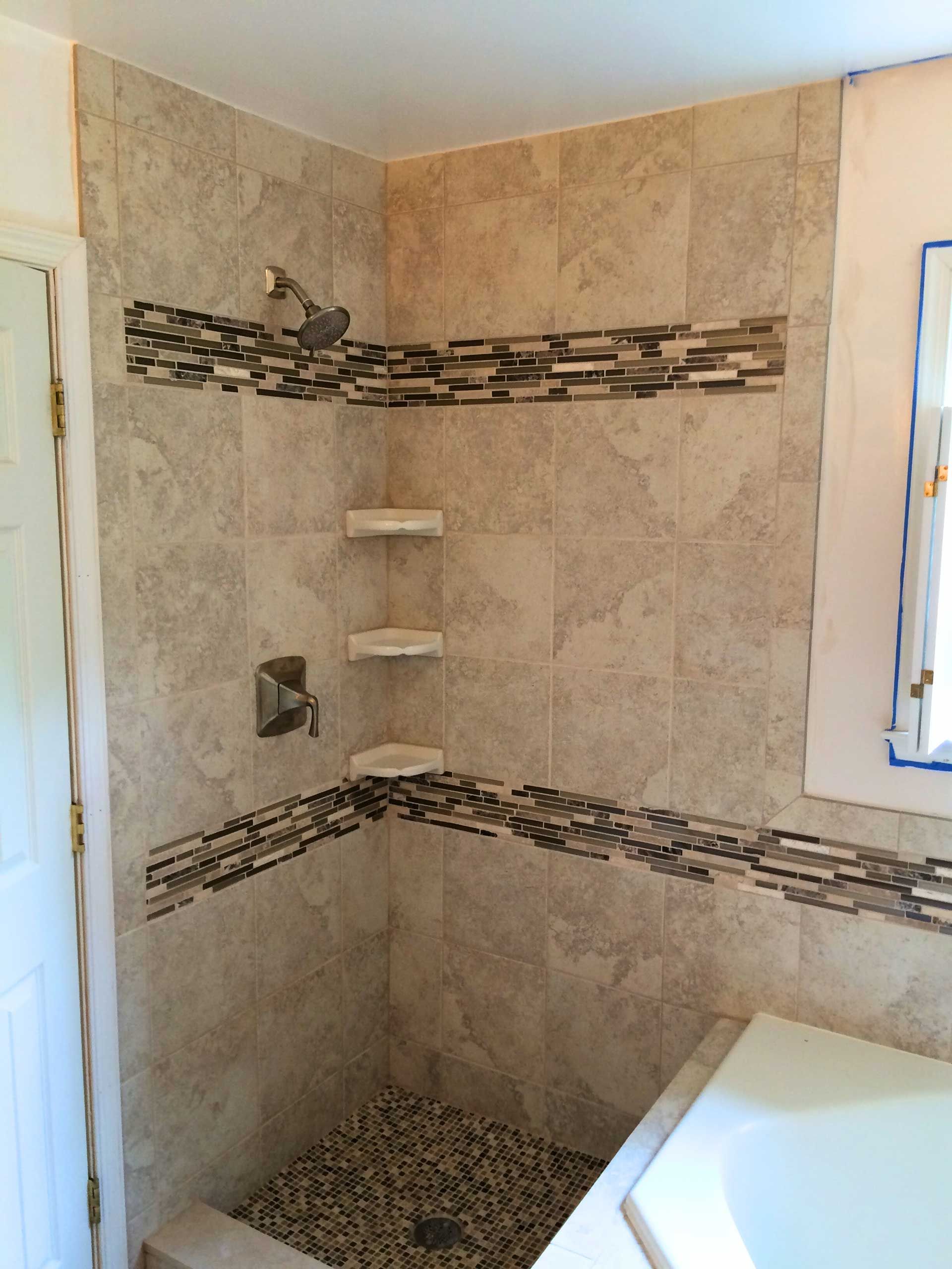 A bathroom with a walk in shower and a bathtub