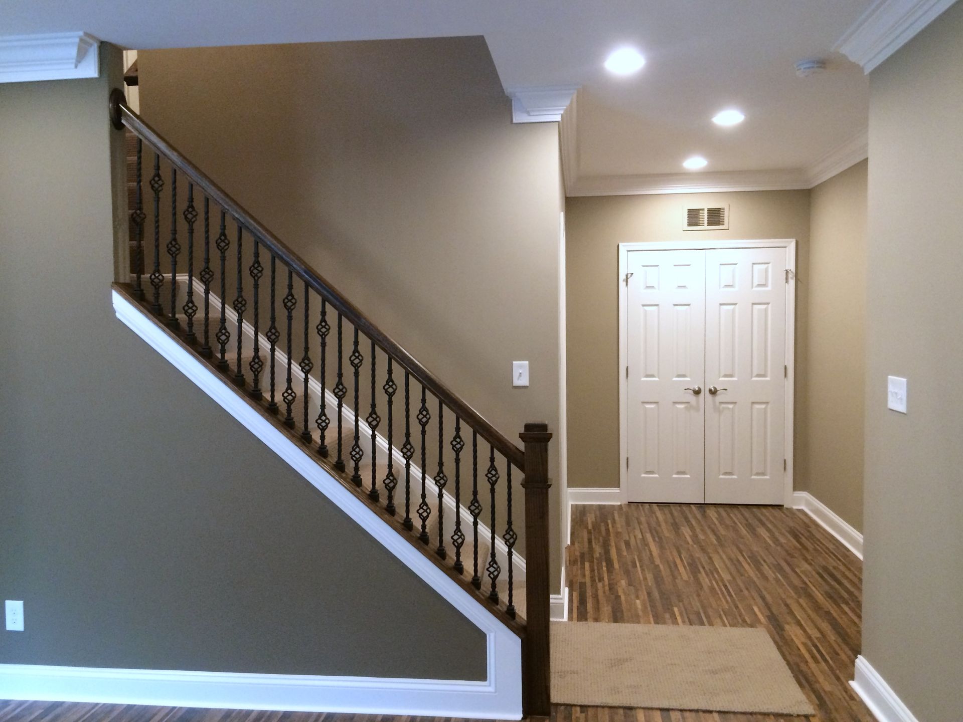 An empty hallway with stairs leading up to the second floor