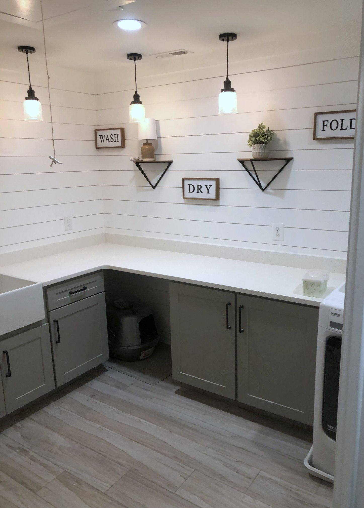 A laundry room with a sink , cabinets , and a washer and dryer.