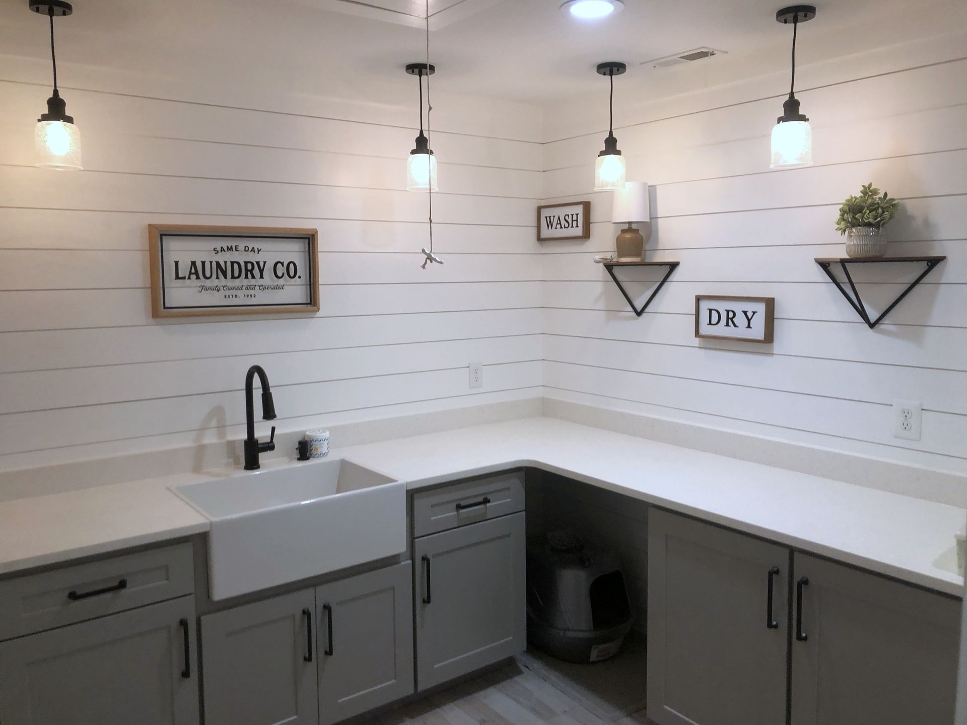 A laundry room with a sink and a sign that says laundry co.