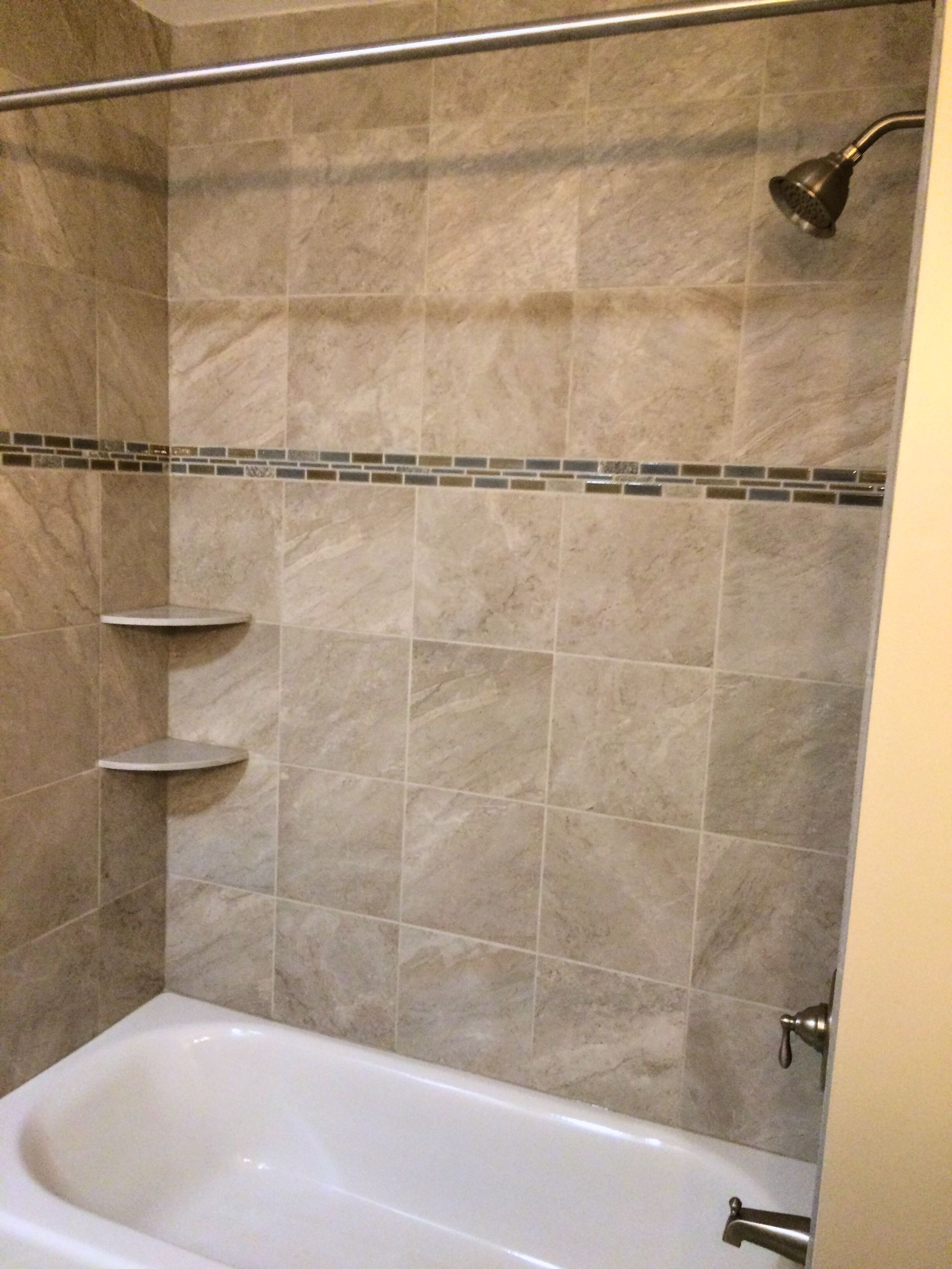 A bathroom with two sinks a mirror and a walk in shower