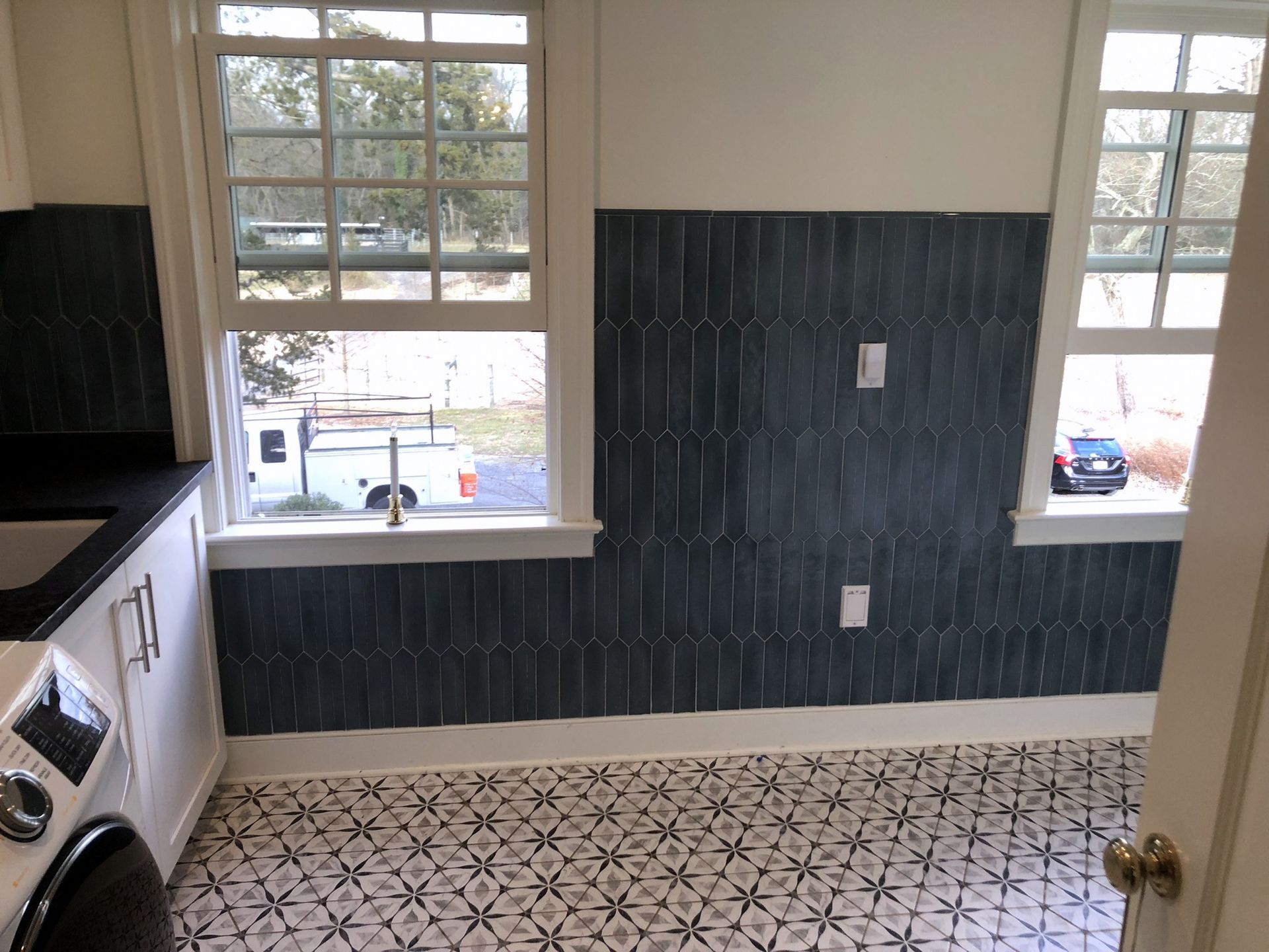 A laundry room with a washer and dryer and a window.