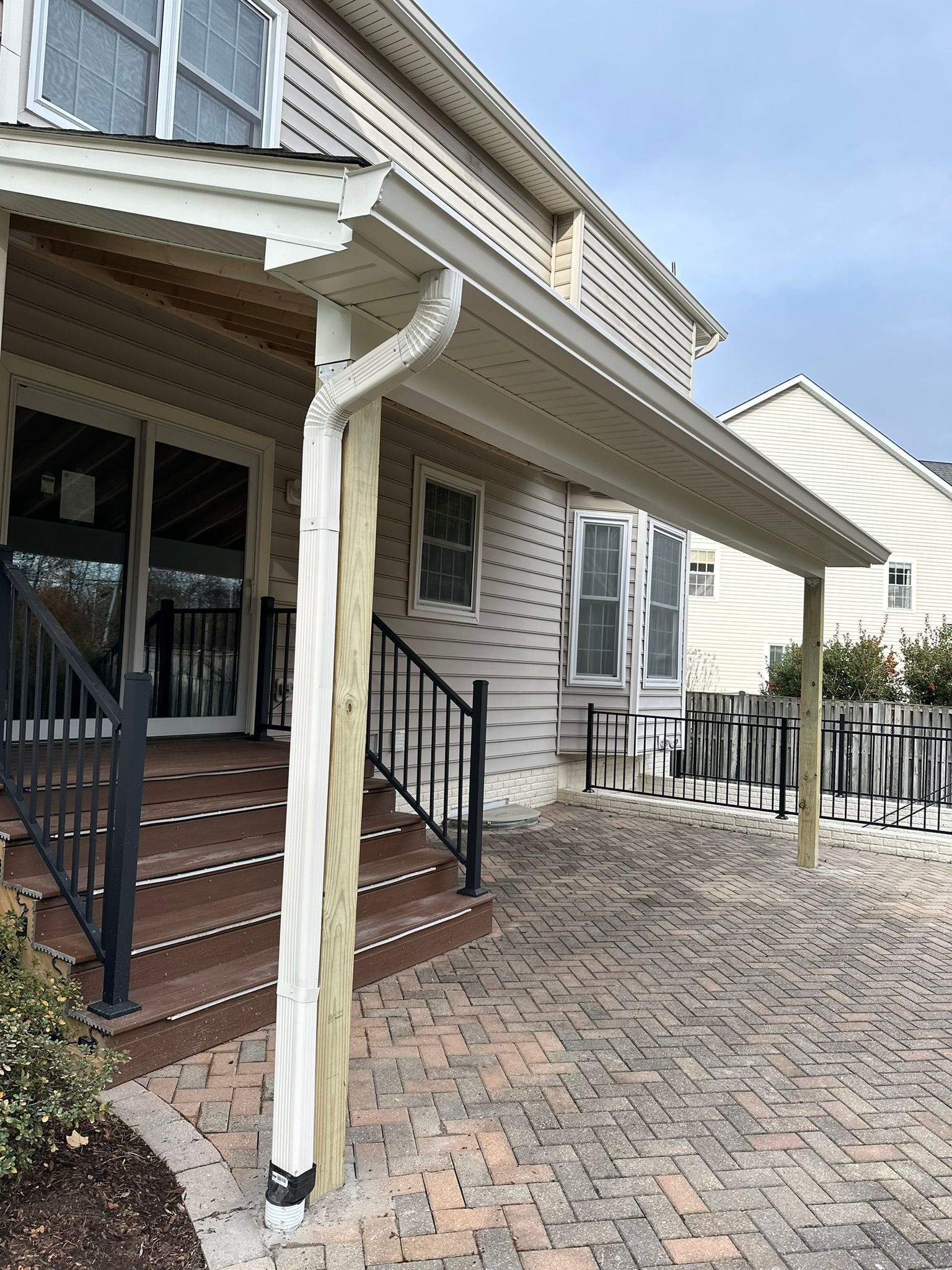 The front of a house with a porch and stairs.