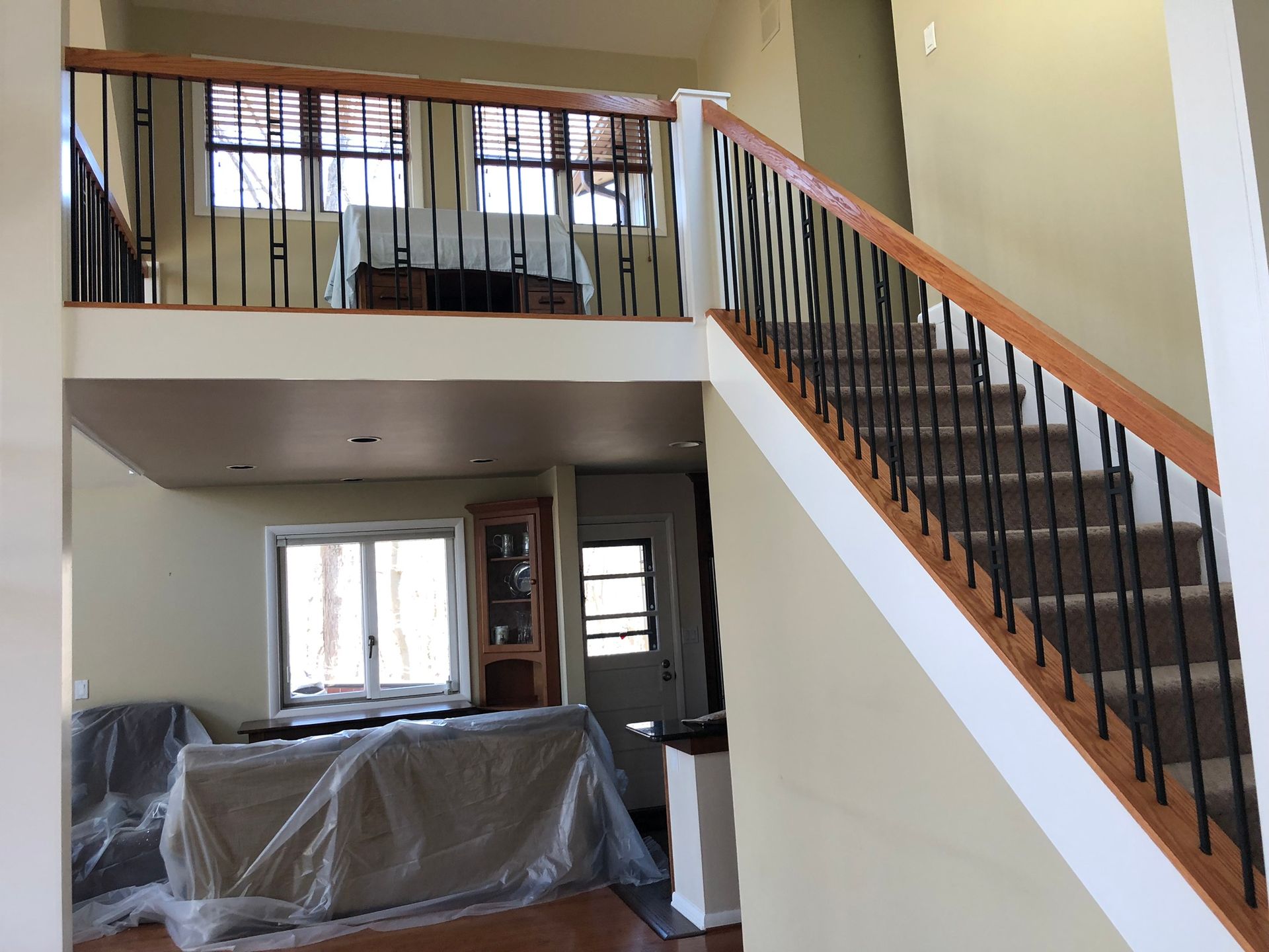 A living room with stairs leading up to the second floor