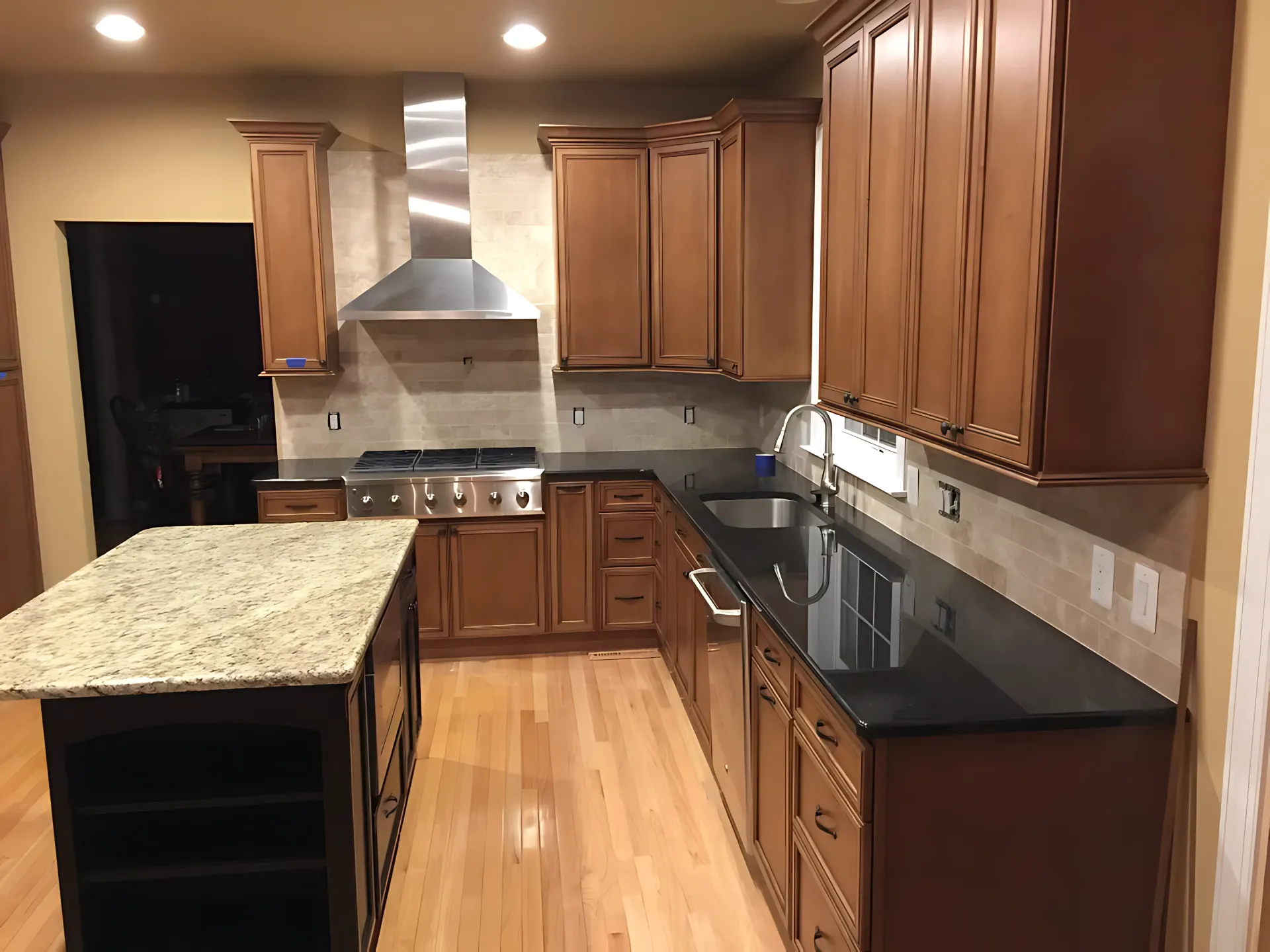 A kitchen with wooden cabinets and granite counter tops