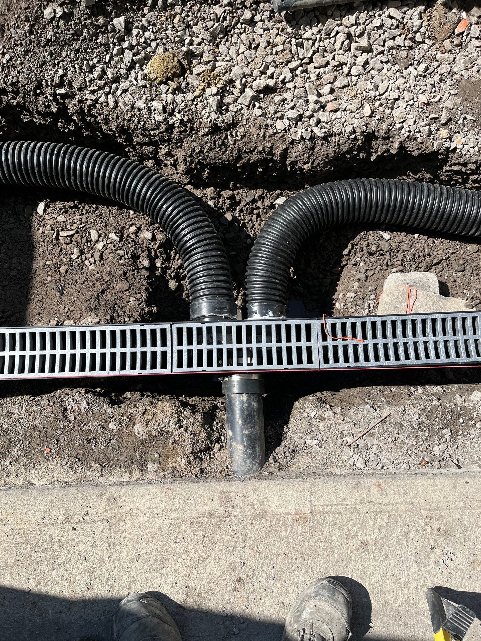 A bunch of pipes are connected to each other in the dirt